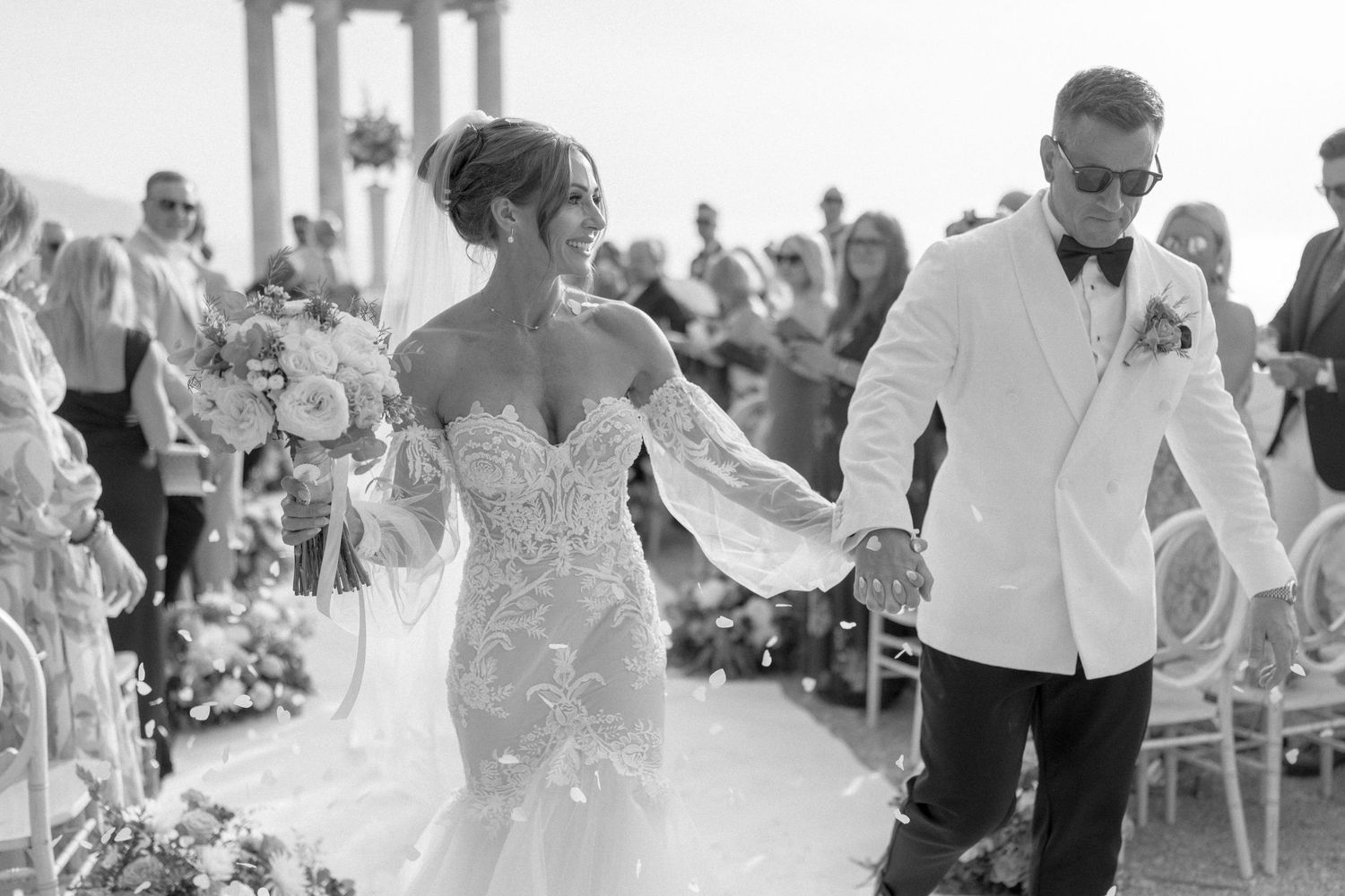 Wedding guests celebrating during a lively outdoor reception with dancing and festivities.