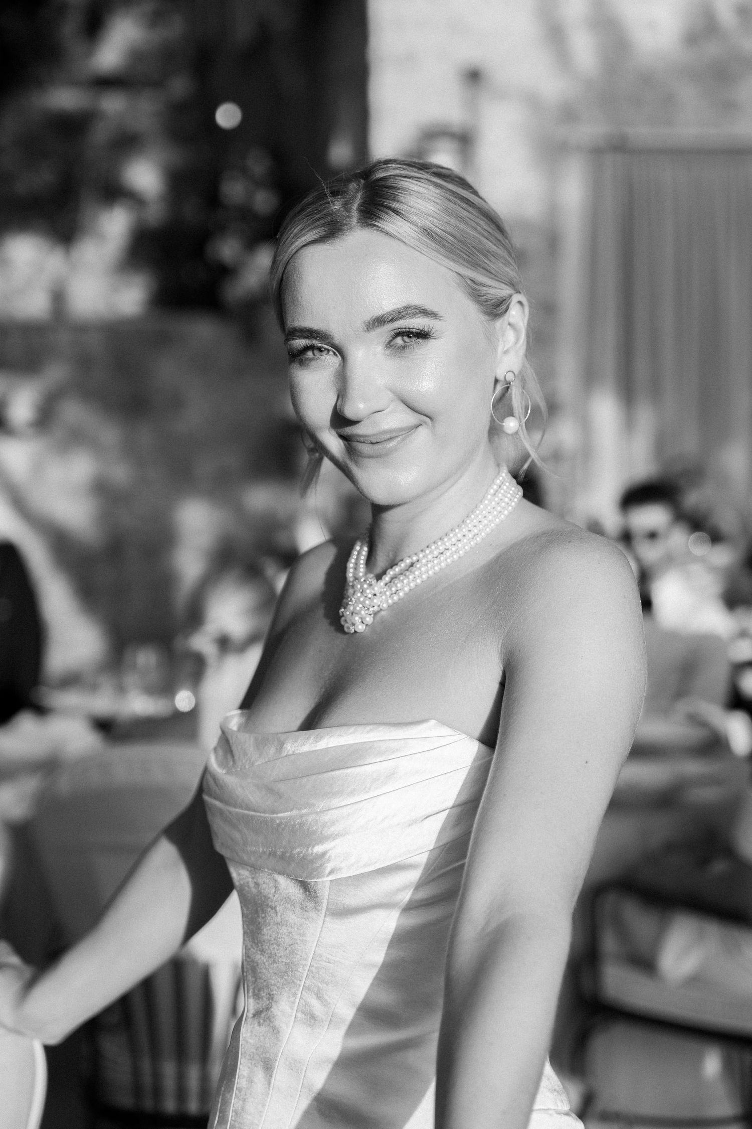 Elegant wedding portrait series with a white strapless gown against a blurred background.