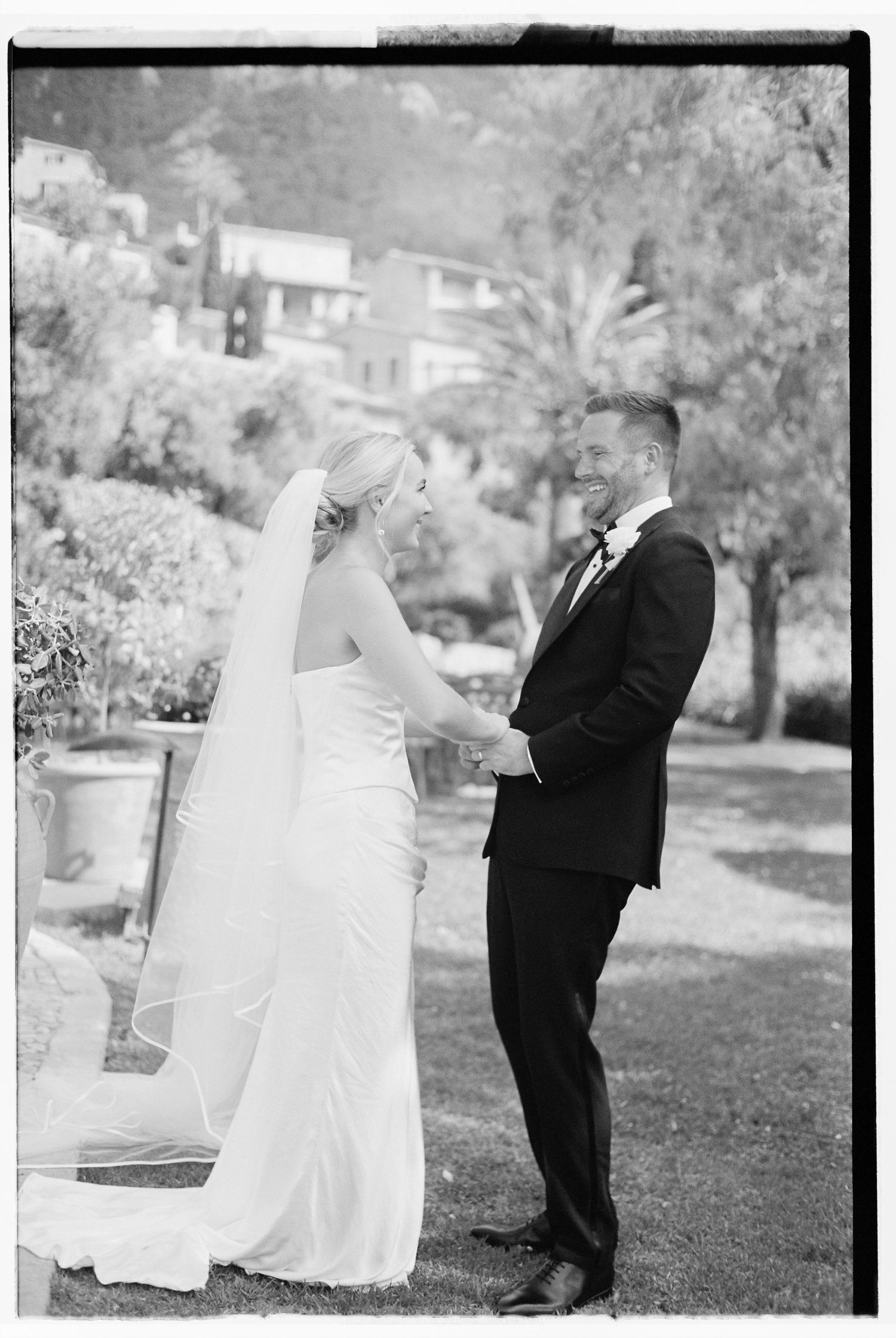 Black and white wedding photos showing couple in formal attire on grassy hillside.