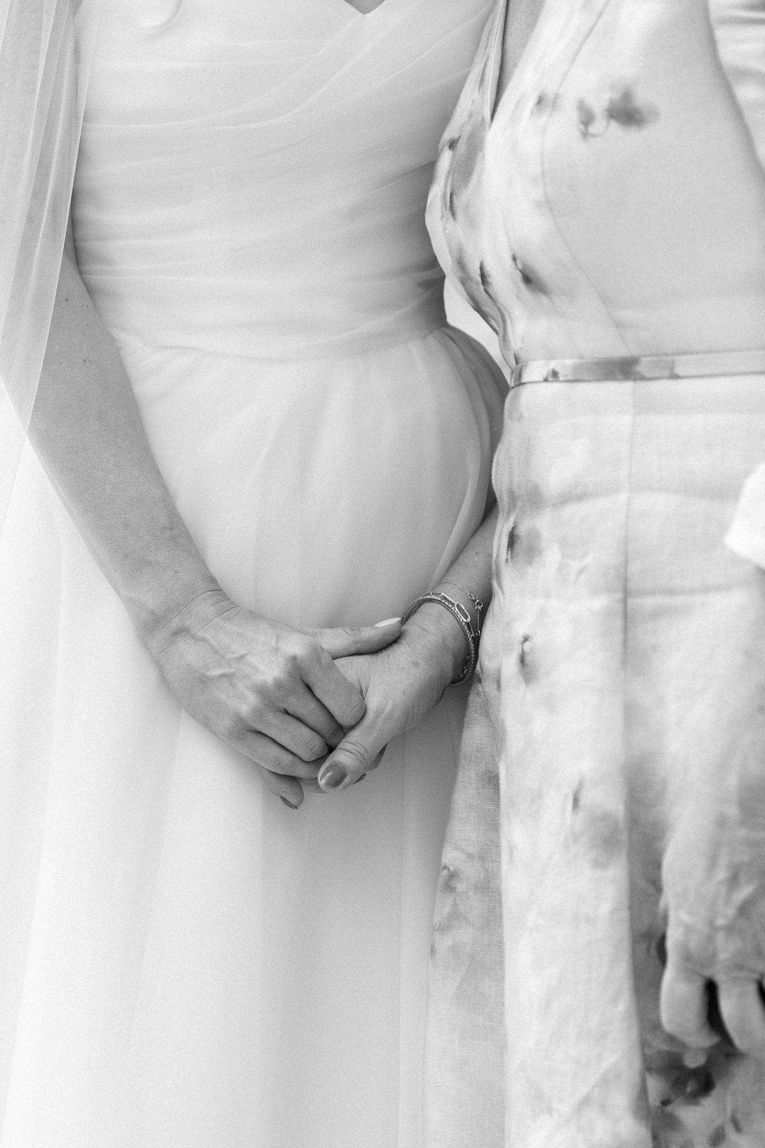 Detail shots of bride and wedding party in white dresses standing together.