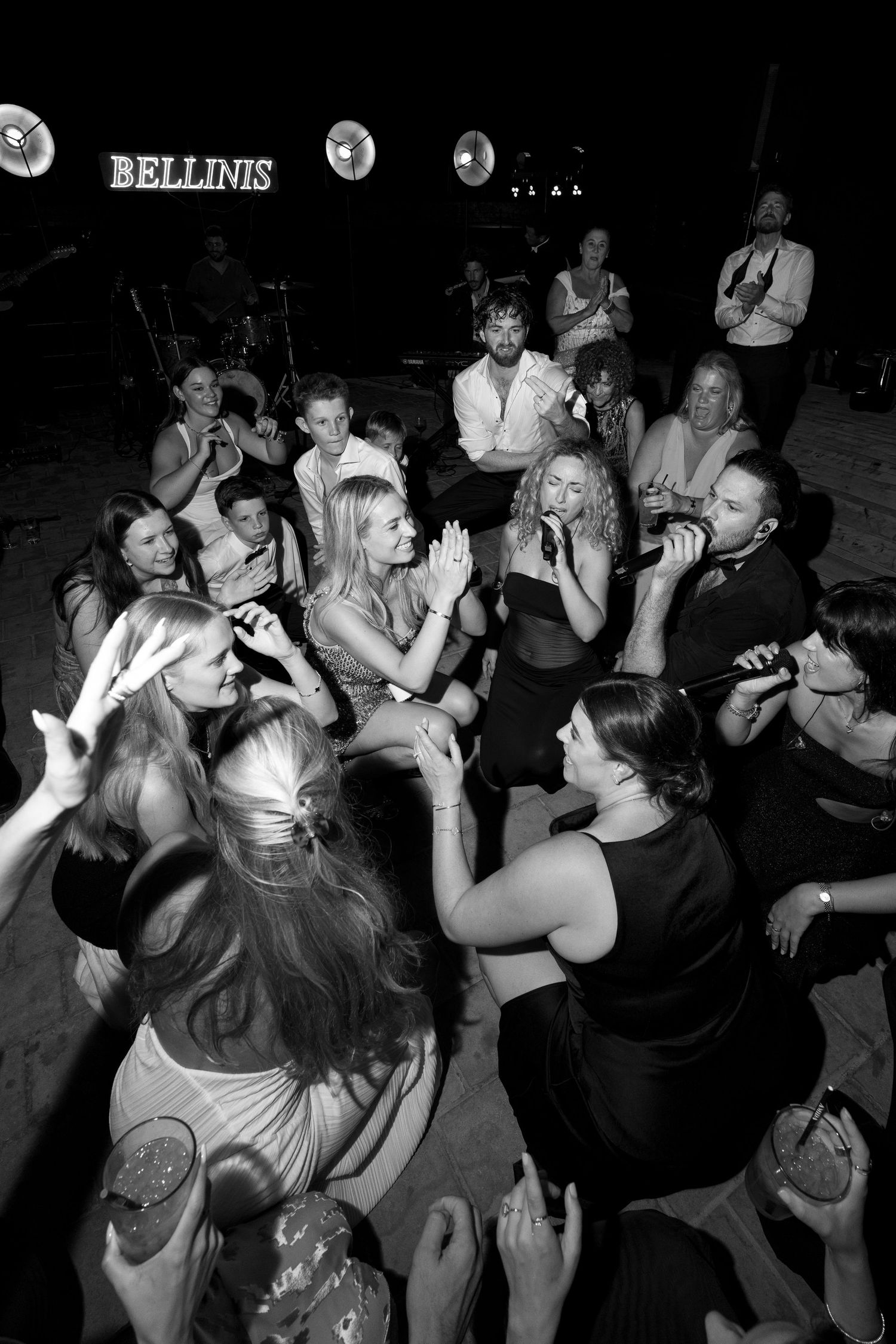 Lively crowd dancing at Bellinis nightclub, captured in black and white photography.