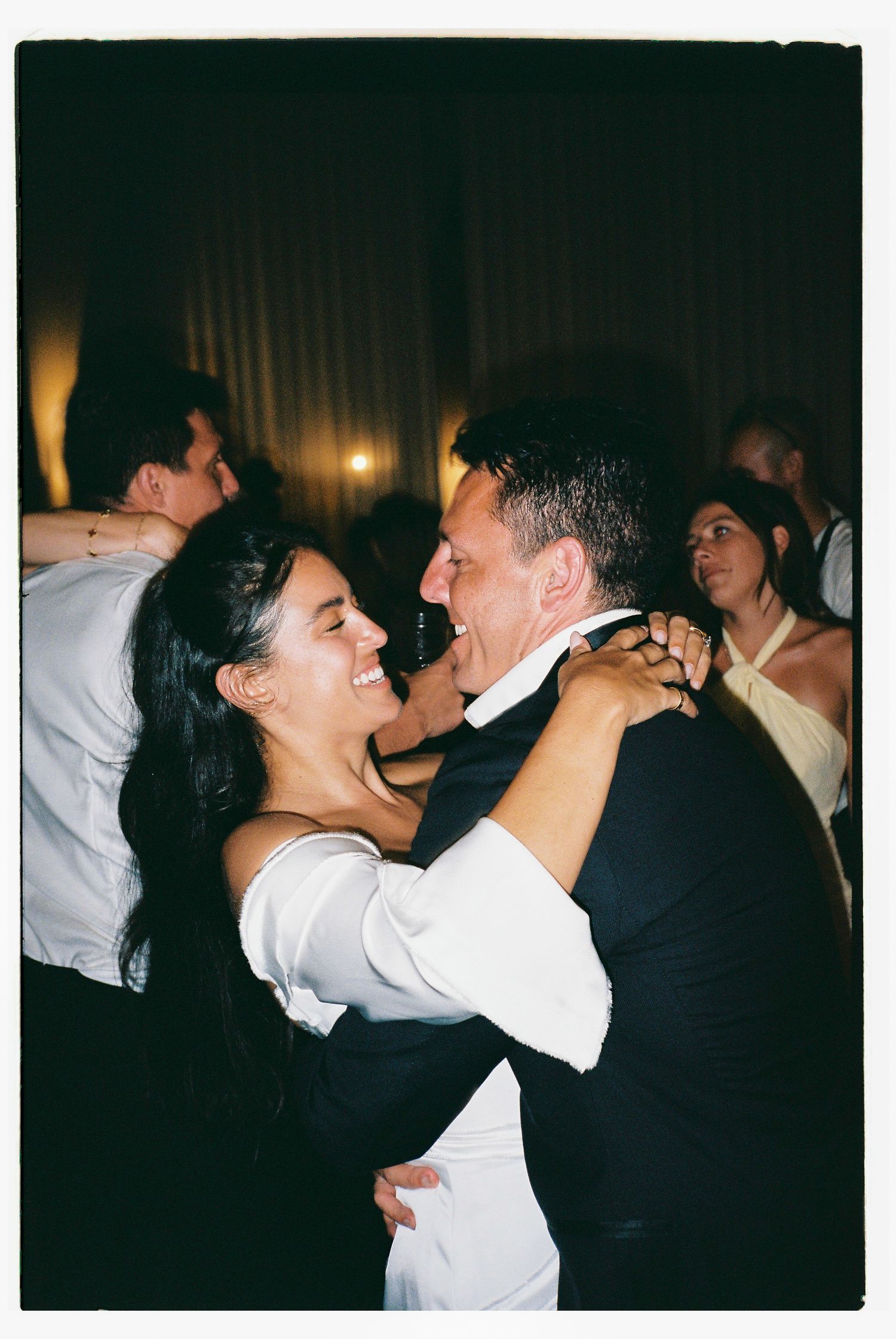 Couples dancing together at a celebration event in formal attire.