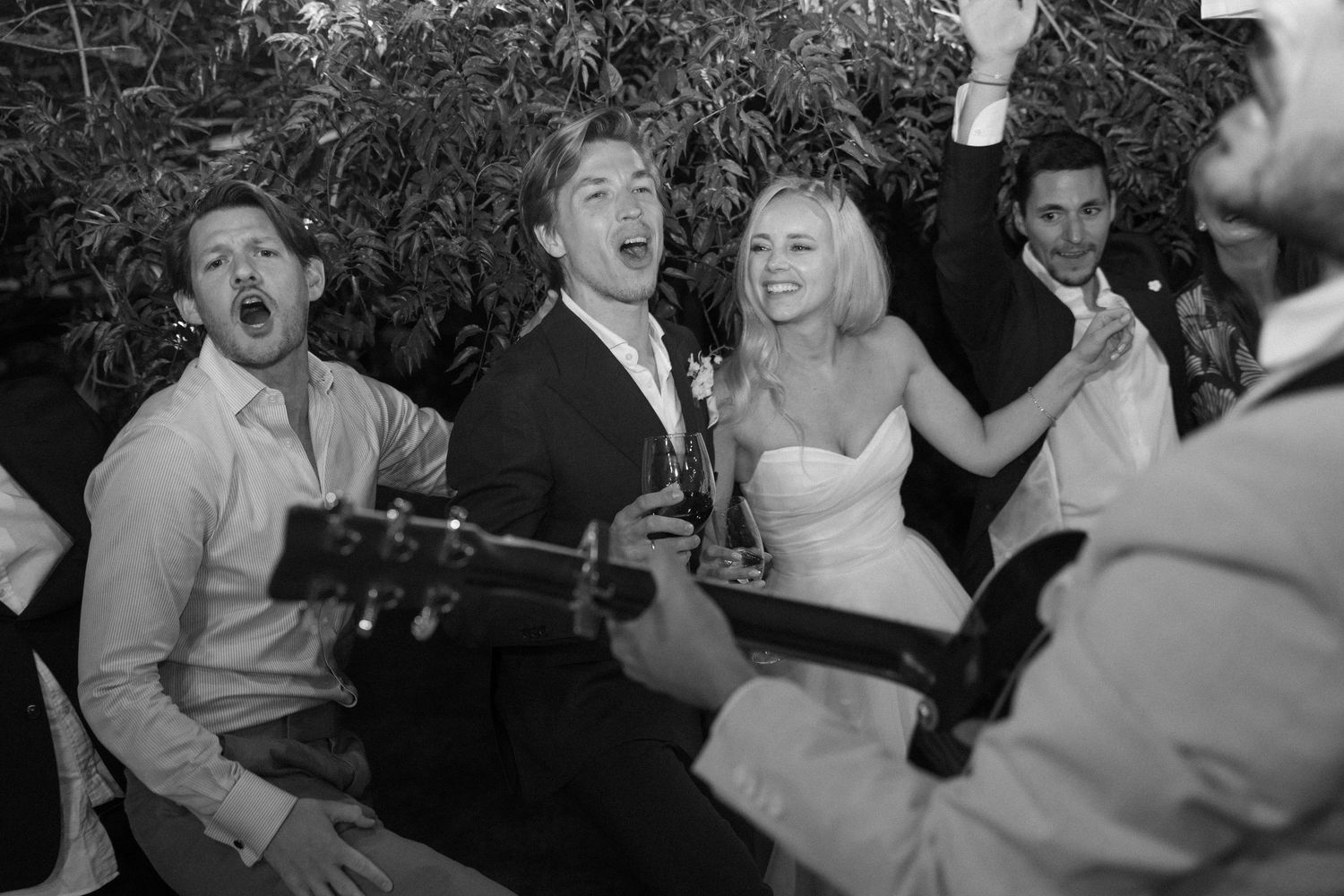 Candid moments of joy and laughter during a wedding reception dance party.
