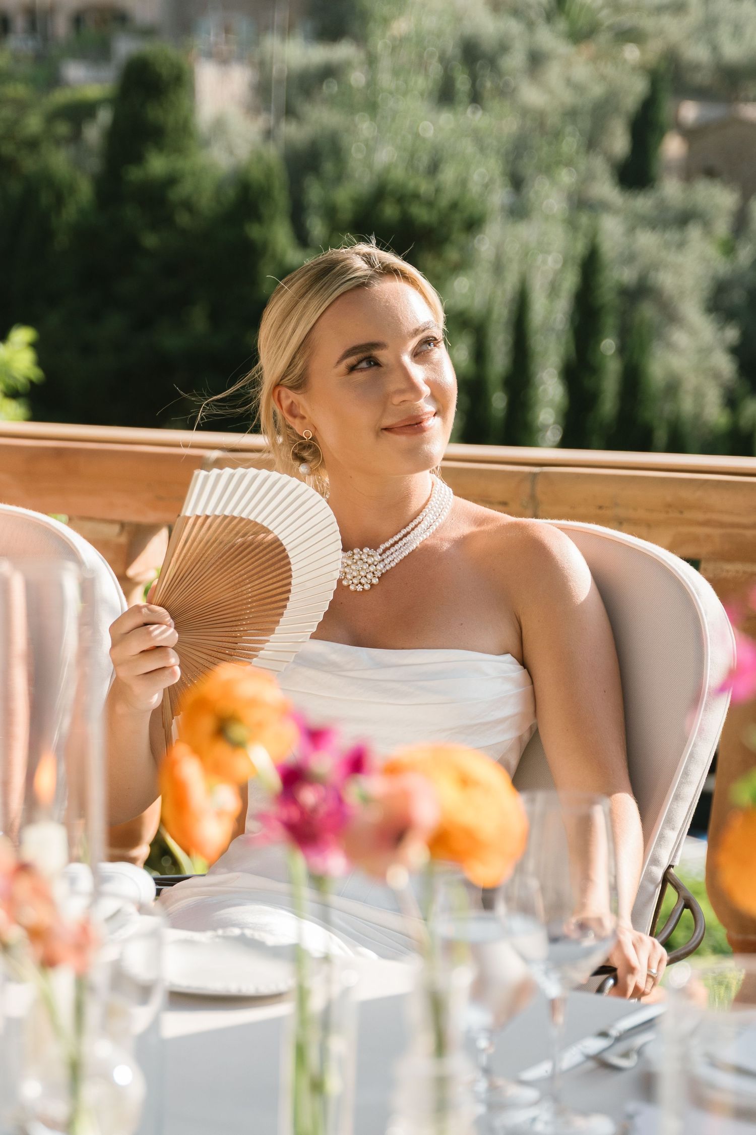 Wedding table setting with elegant place settings and colorful floral arrangements.