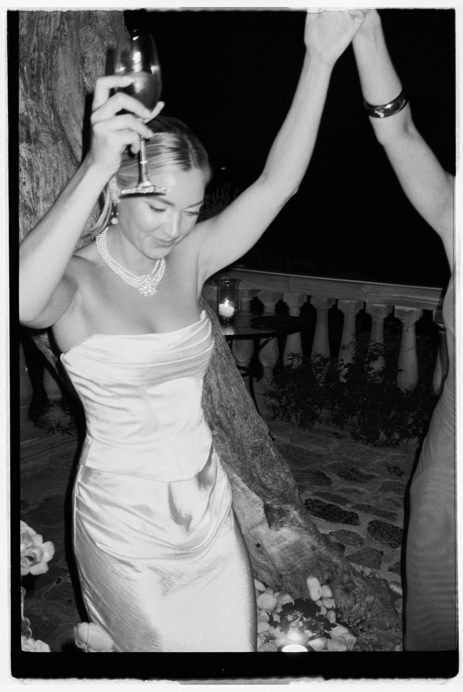 Wedding celebration at night with dancing and joyful moments.