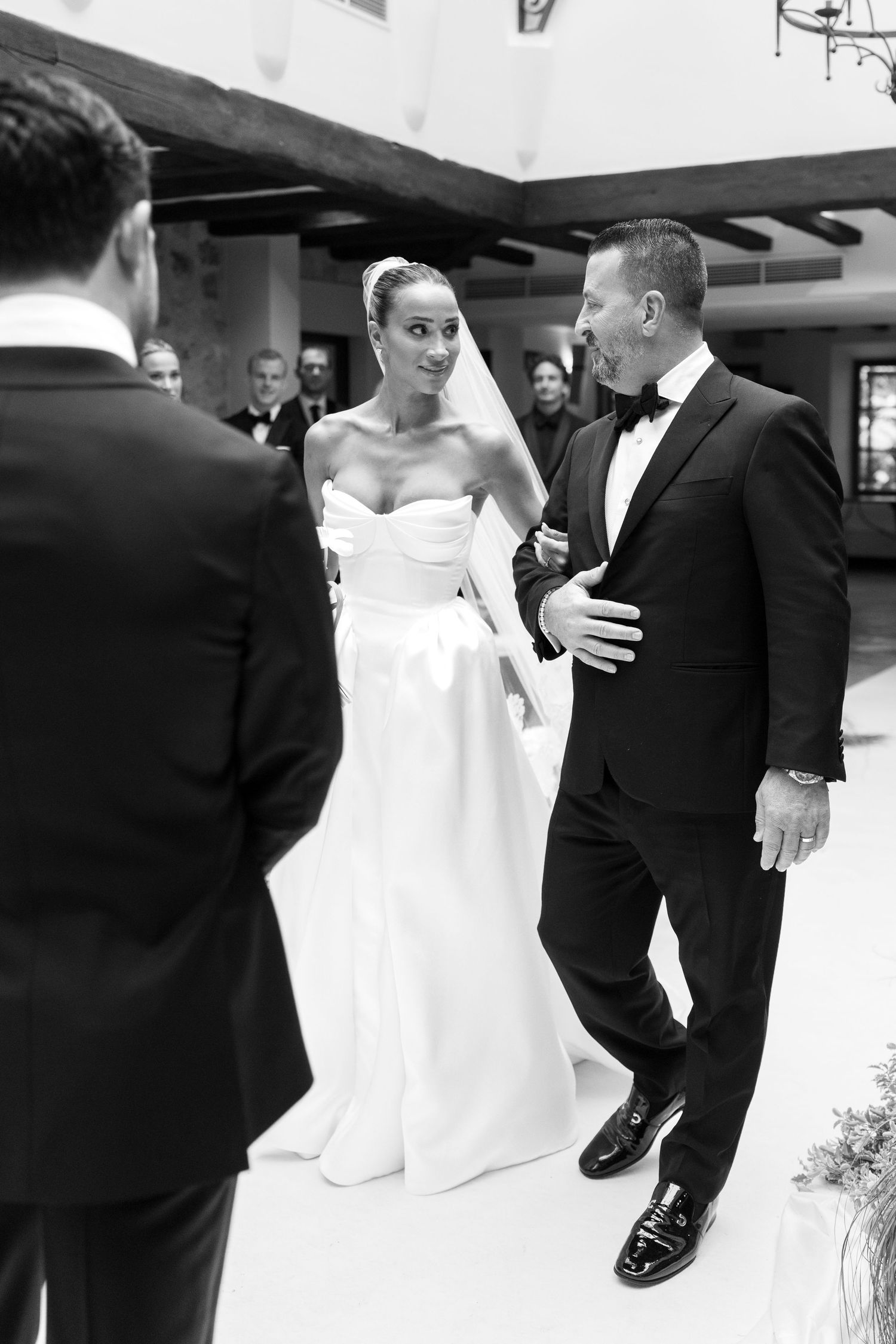 A series of black and white wedding photos showing a couple dancing and embracing in formal attire.