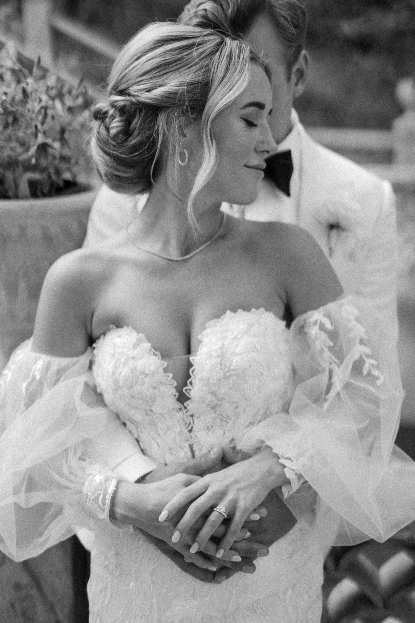 A series of black and white photos showing a bride in a strapless wedding gown holding flowers in an outdoor setting.