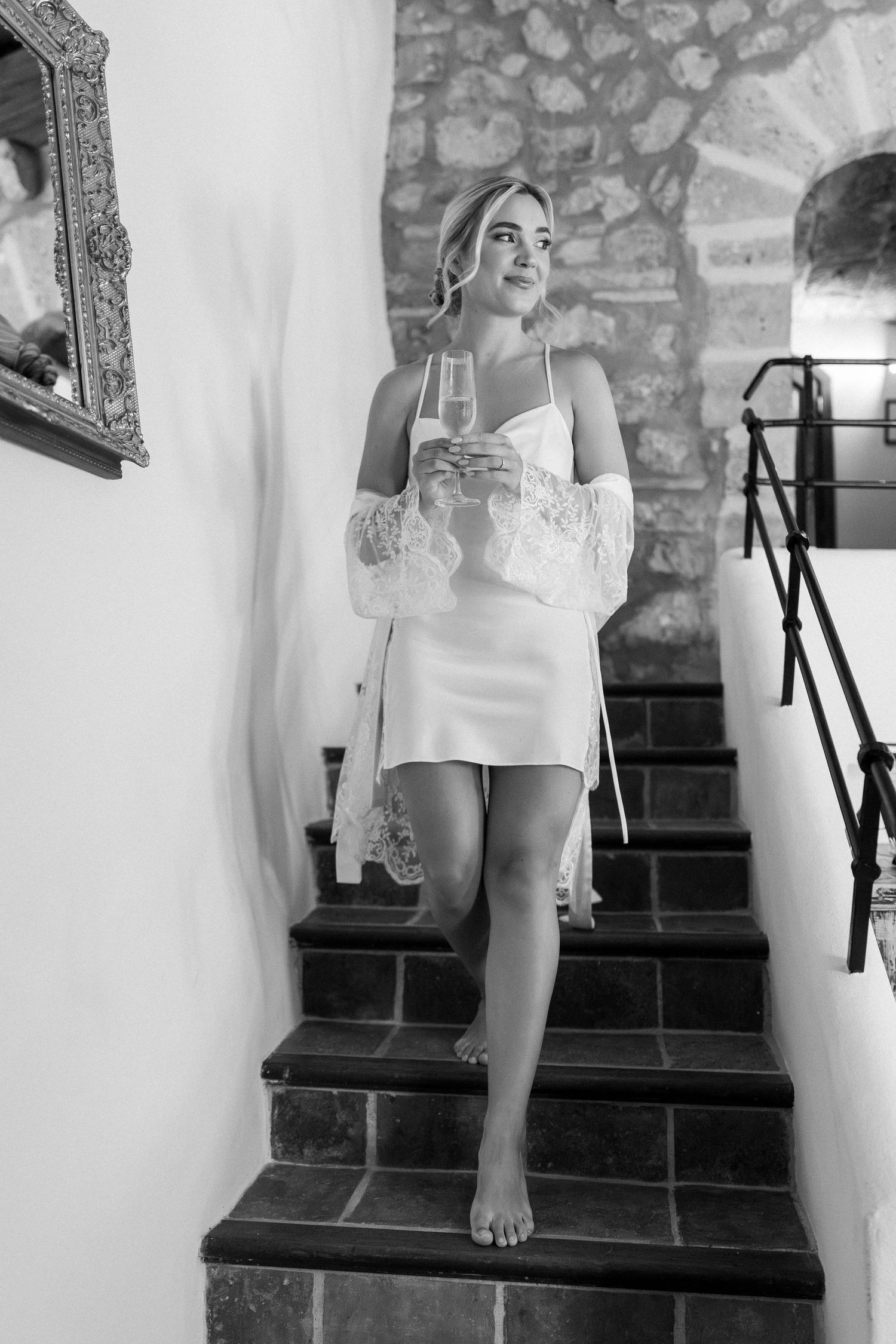 Wedding party descending stone stairs in a Mediterranean villa.