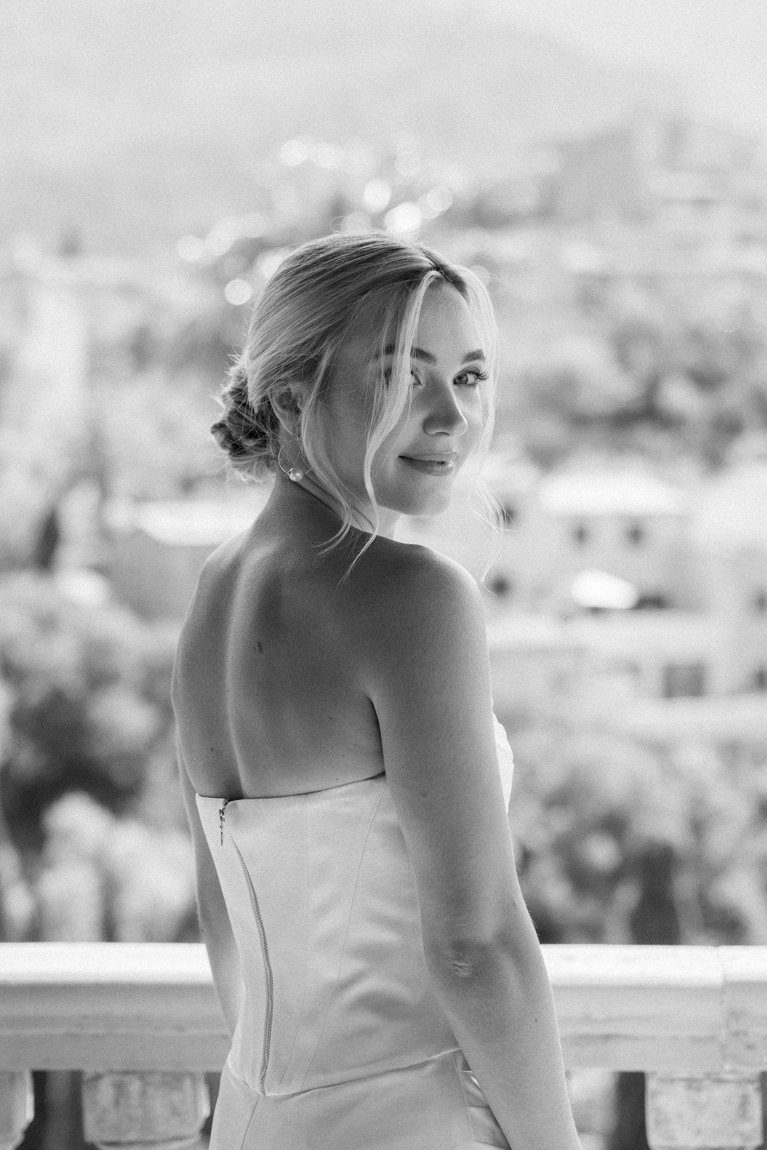 Elegant white wedding dress photographed against a scenic mountain backdrop.