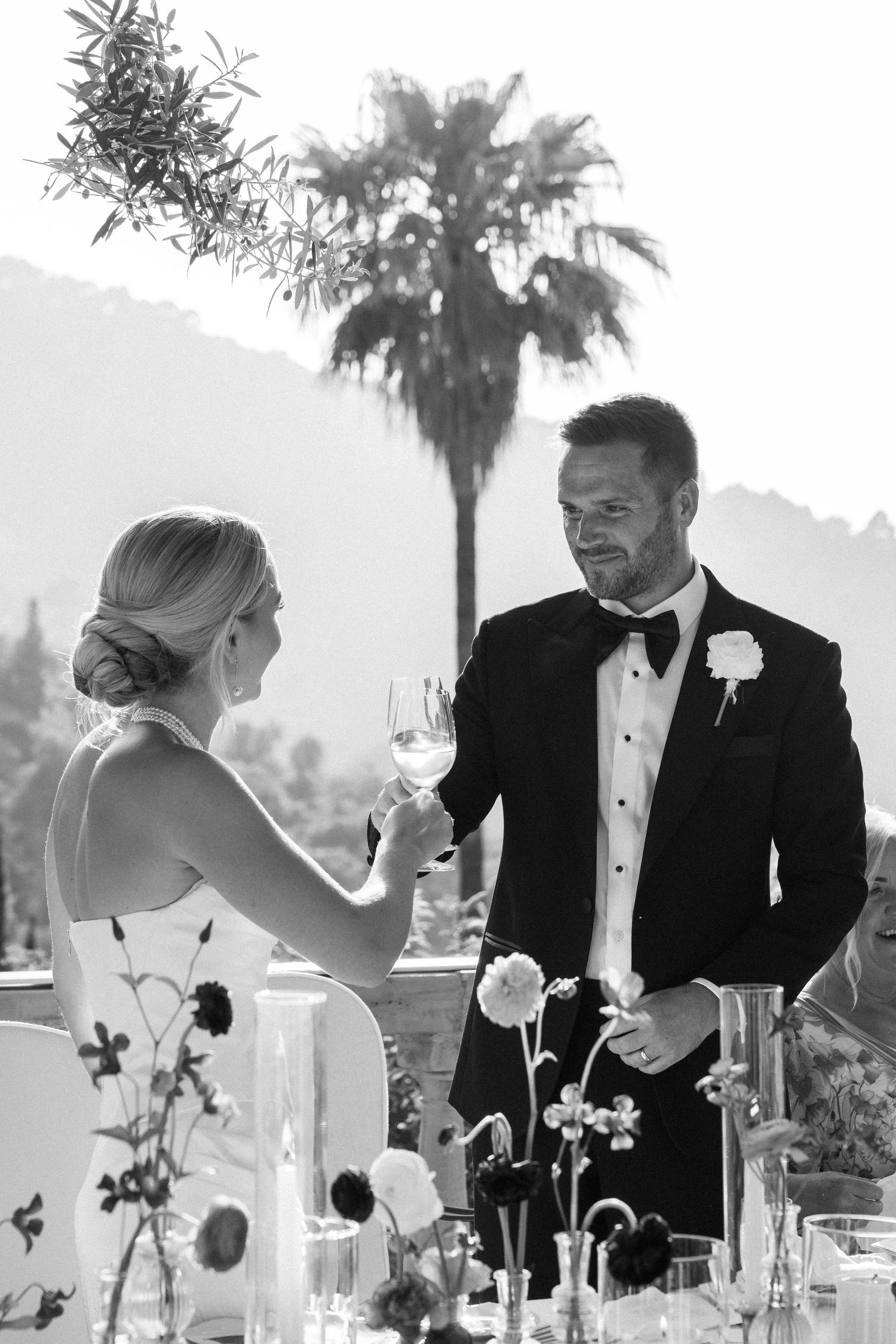 Intimate moments shared during a formal outdoor wedding celebration.