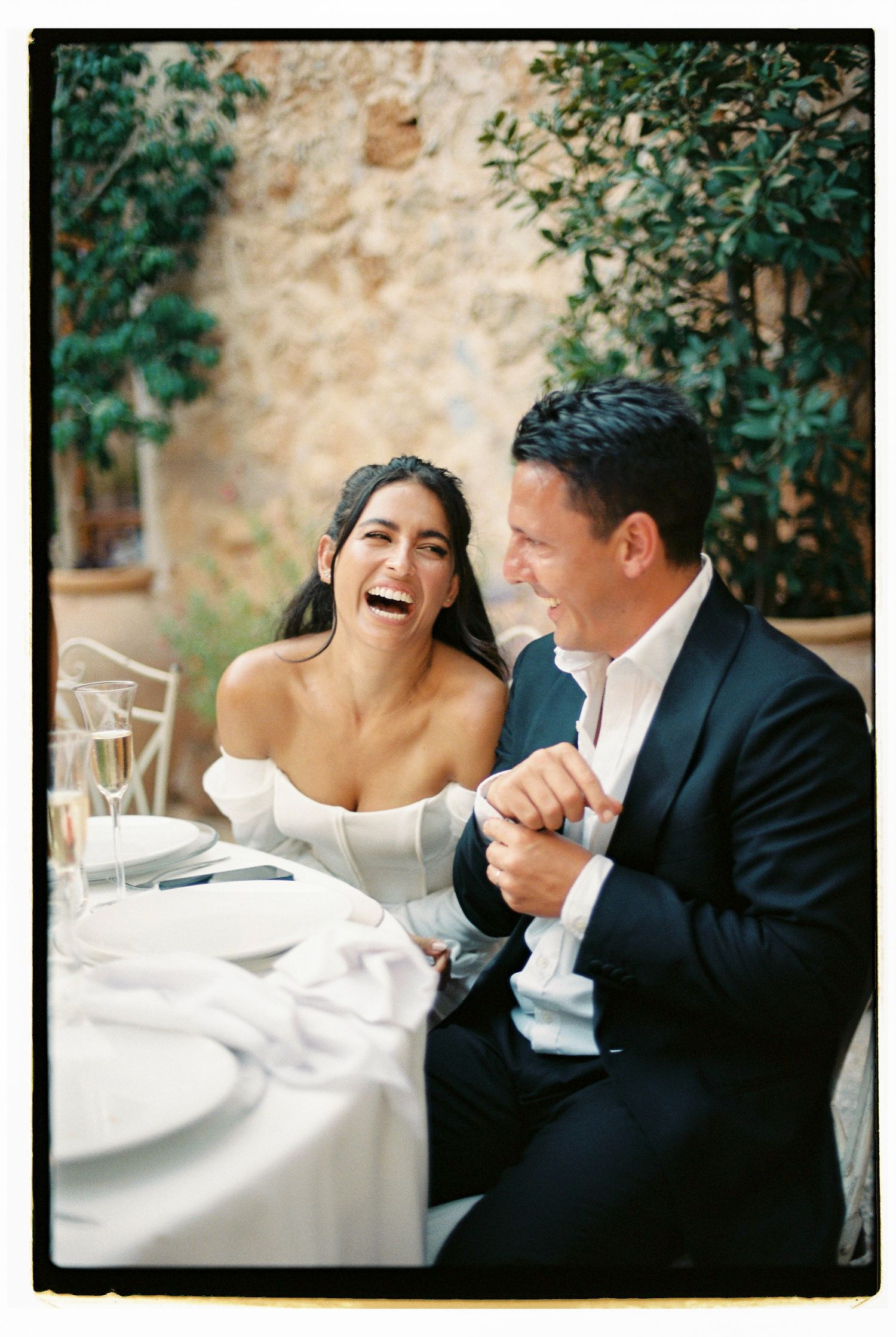 Candid moments of joy and laughter at an outdoor wedding reception at Sa Font Seca.