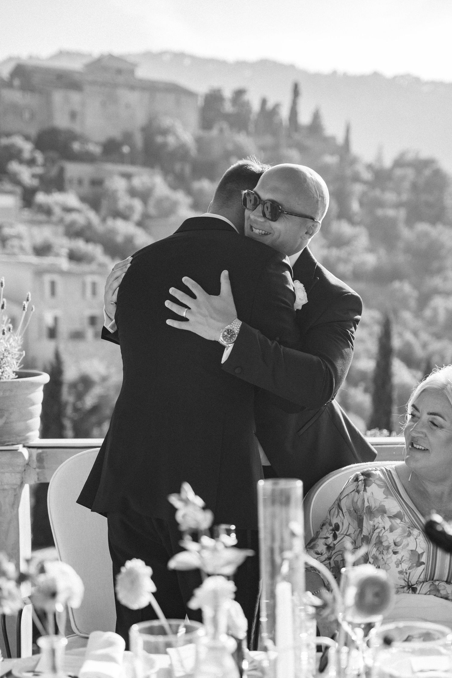 Emotional embraces shared during a wedding reception celebration.