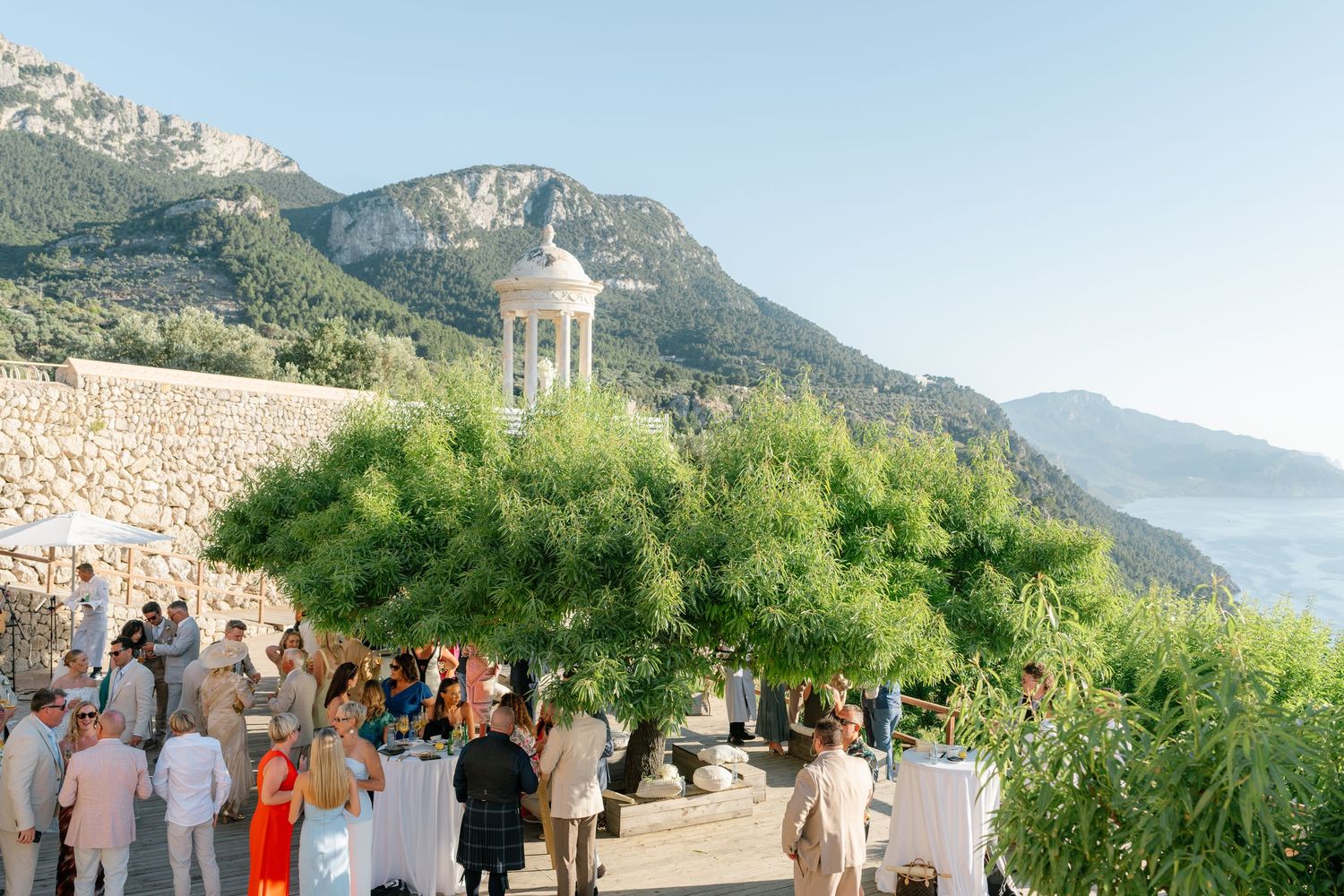 A beautiful outdoor wedding ceremony setup with white chairs and mountain views in the background.