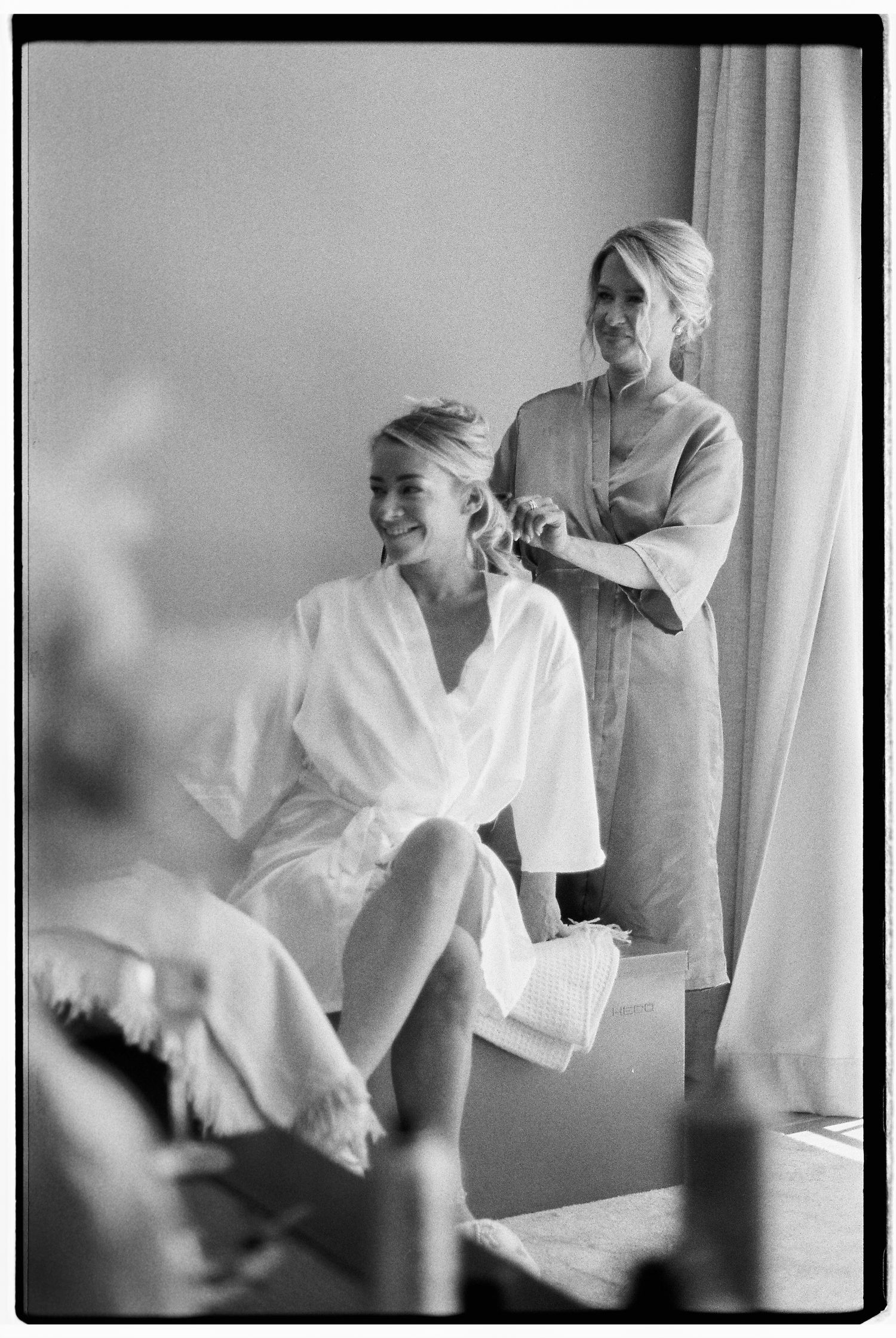 Getting ready scene with people in white robes captured in black and white.