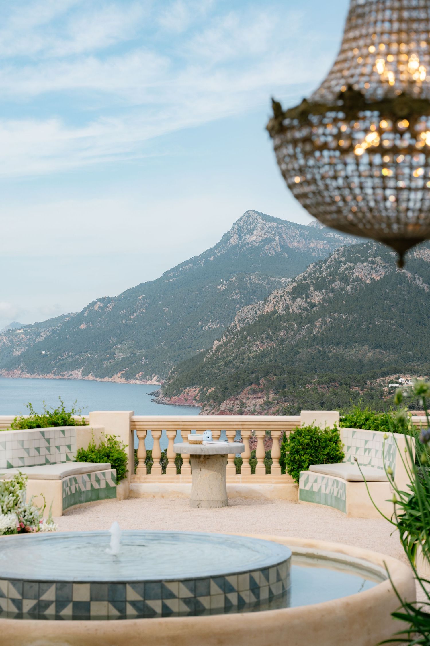 A luxurious outdoor terrace with mountain and sea views decorated for a wedding celebration.