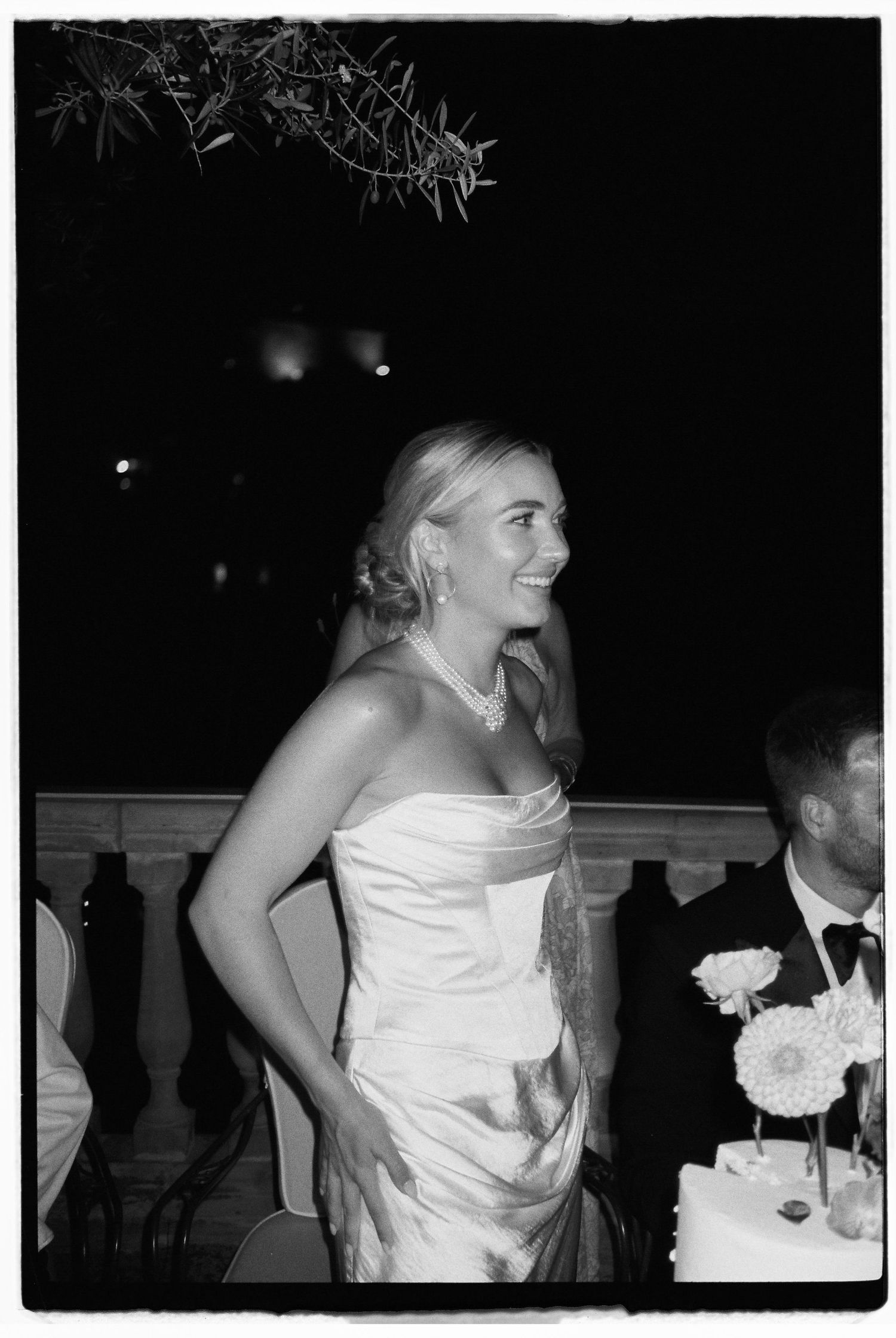Black and white candid reception moment showing joy and laughter.