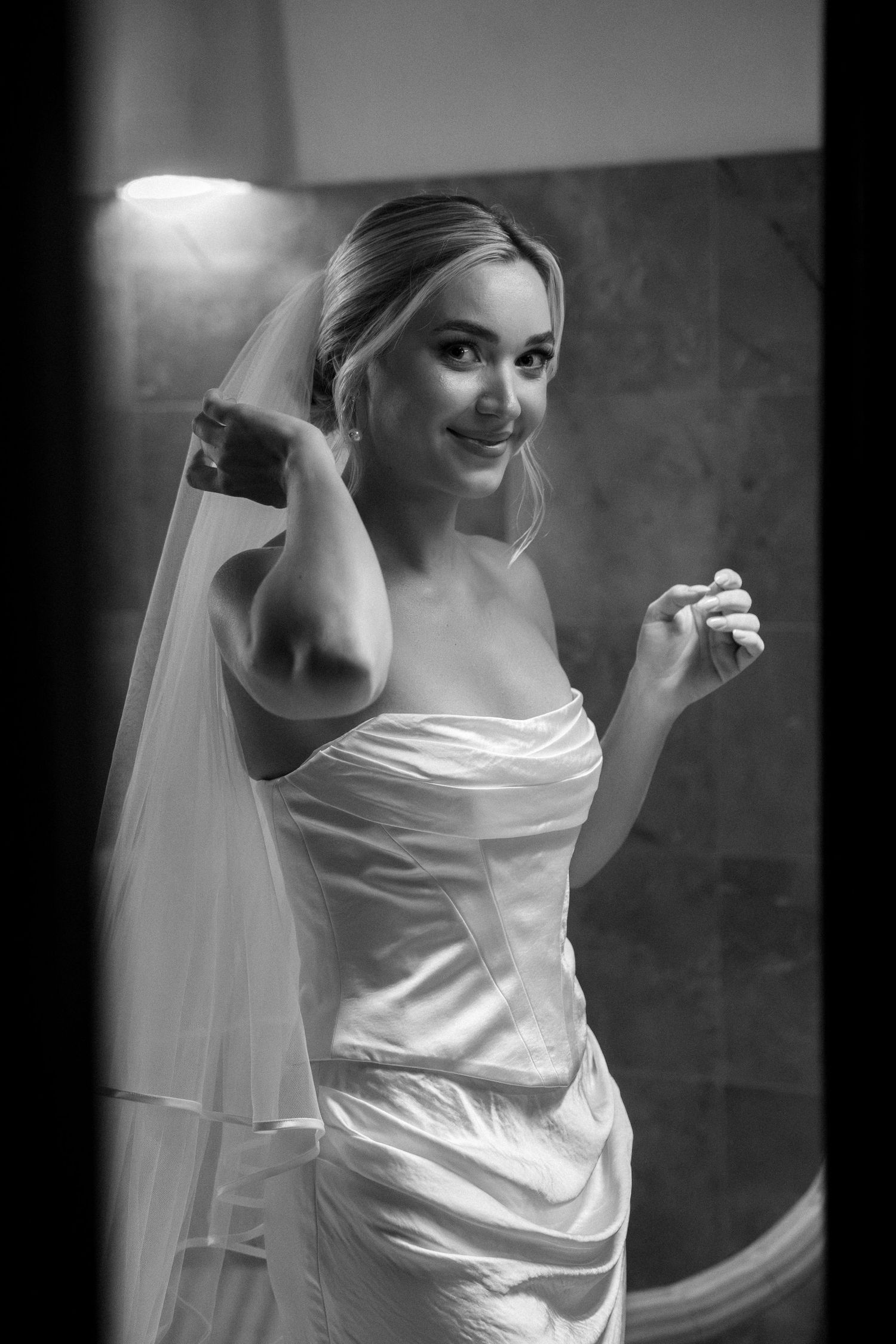 Artistic black and white bridal portraits showing details of a classic white wedding gown.