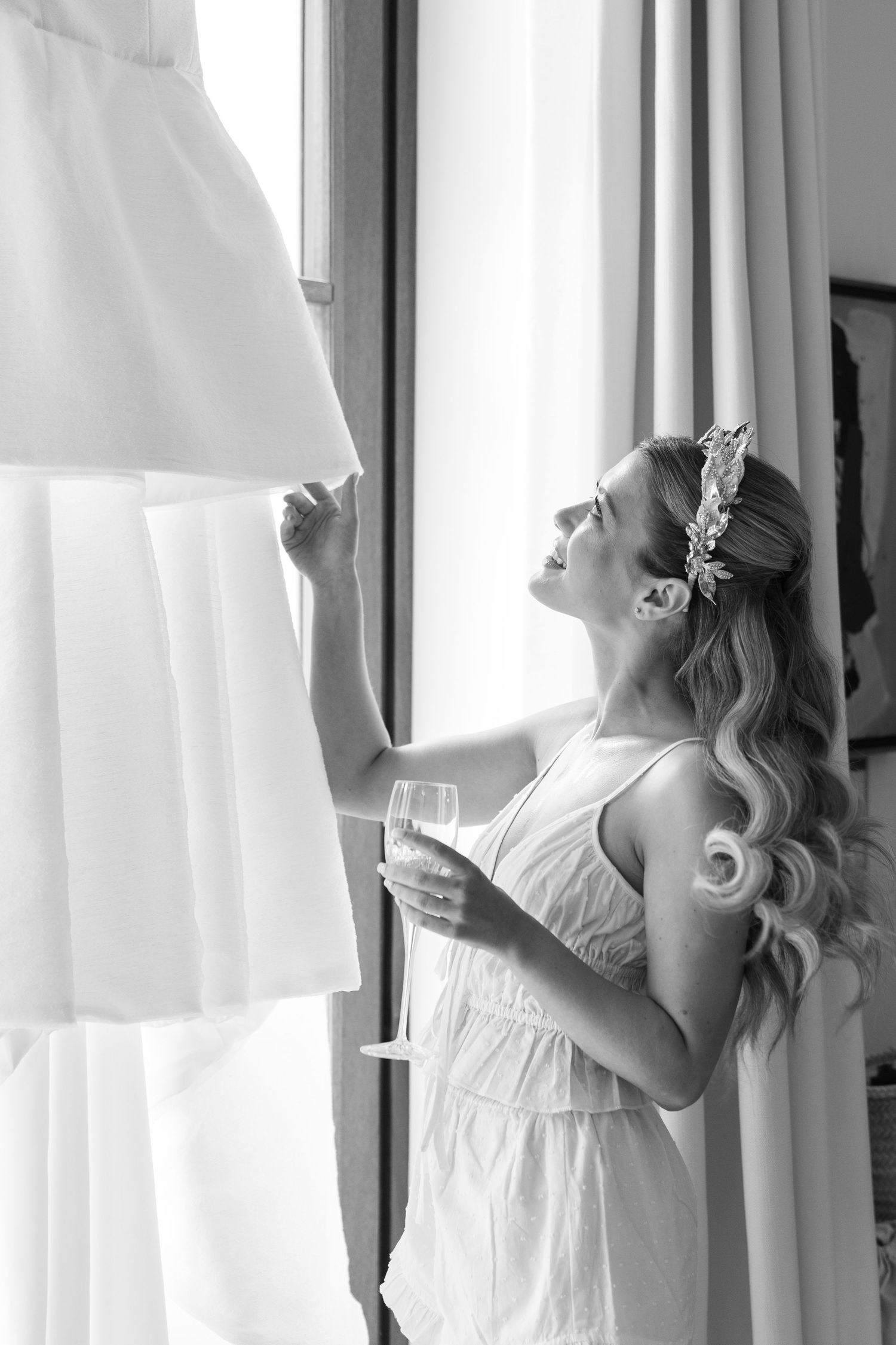 Sequence of someone adjusting white curtains in a bright, sunlit room.