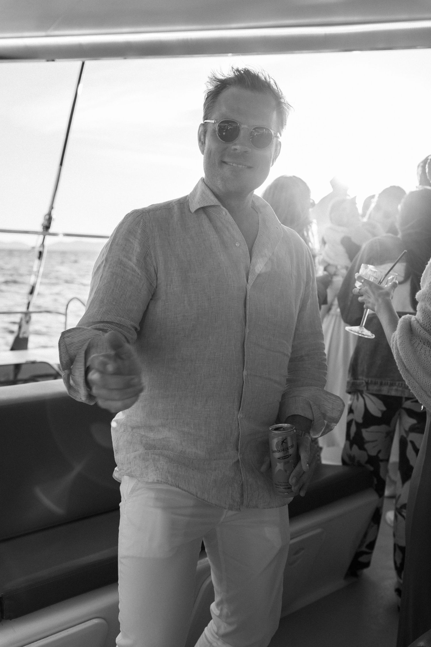 Guests mingle and chat during a casual boat party gathering.