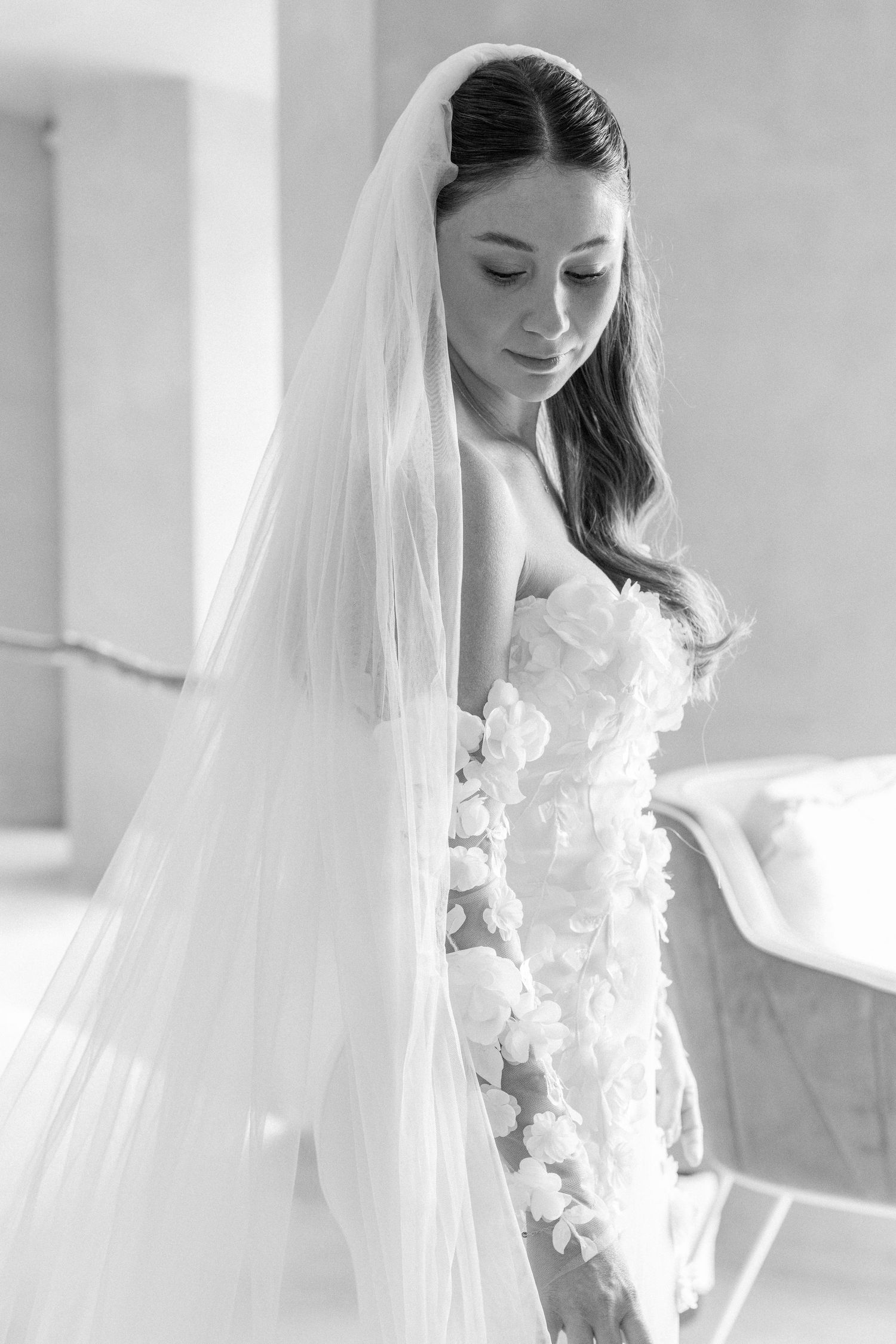 Black and white bridal portraits showcasing delicate veil and floral dress details.