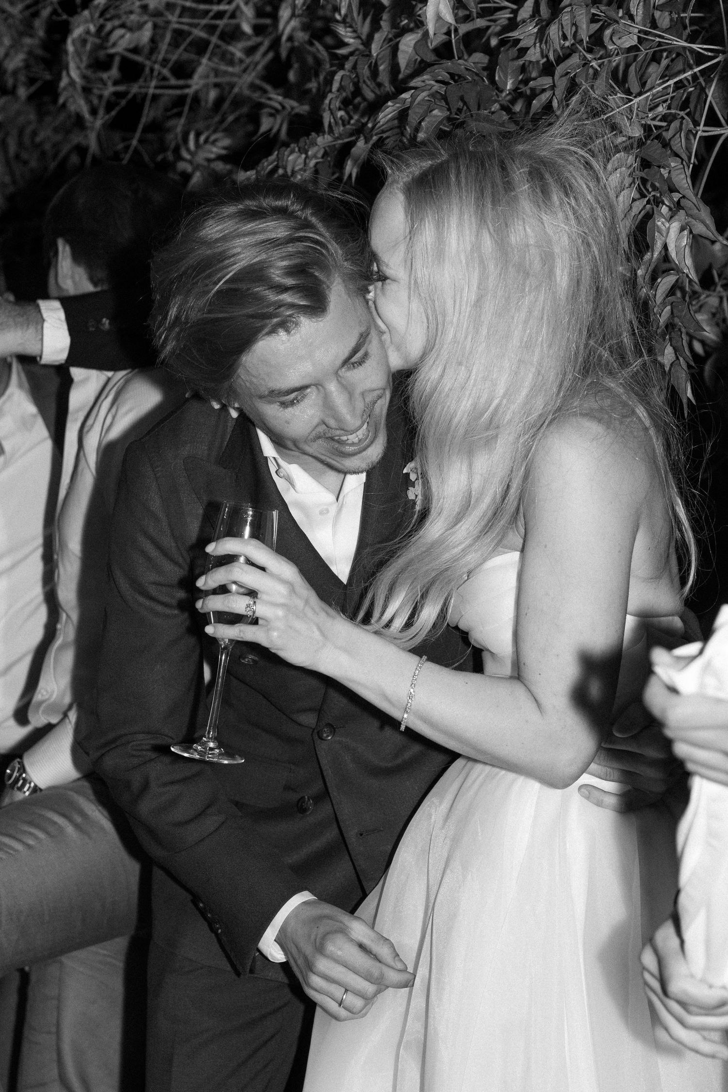 Intimate moments shared between wedding guests during an evening celebration.