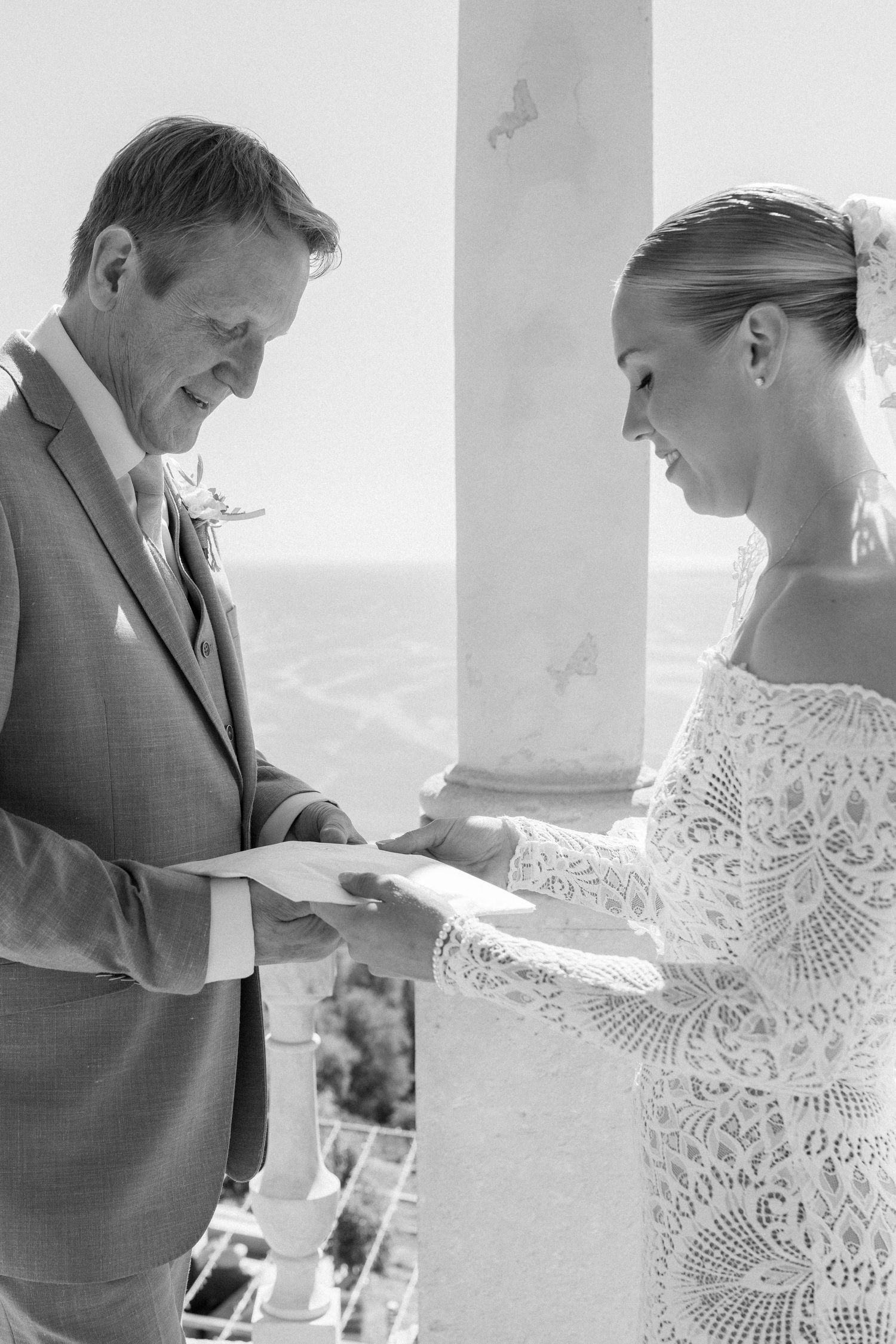 Intimate black and white wedding moments captured on a sunlit terrace.