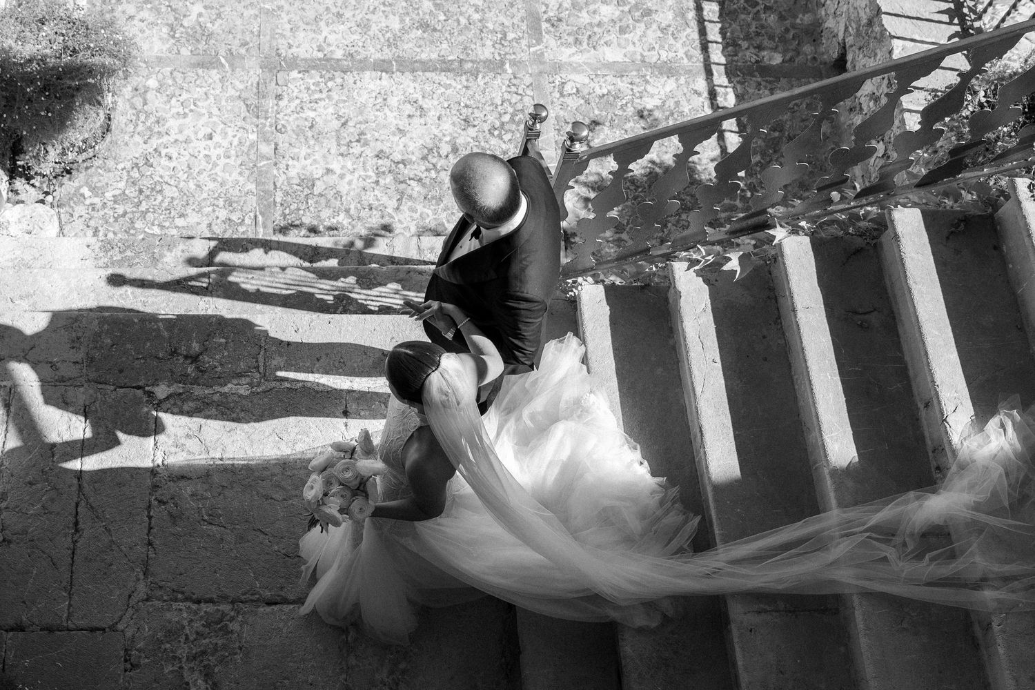 Black and white film strips showing wedding ceremony moments at a rustic stone venue.