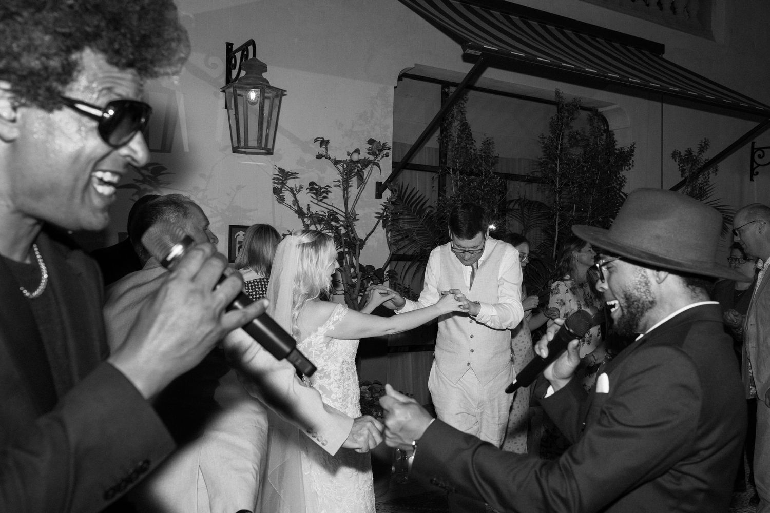 Wedding reception dance floor with guests celebrating and dancing.
