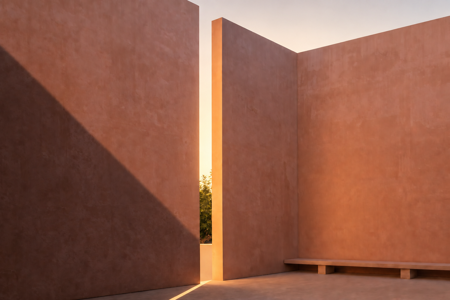Neuendorfer House. Minimalist terracotta adobe walls with dramatic light gap at golden hour, casting warm shadows on smooth stucco surfaces.