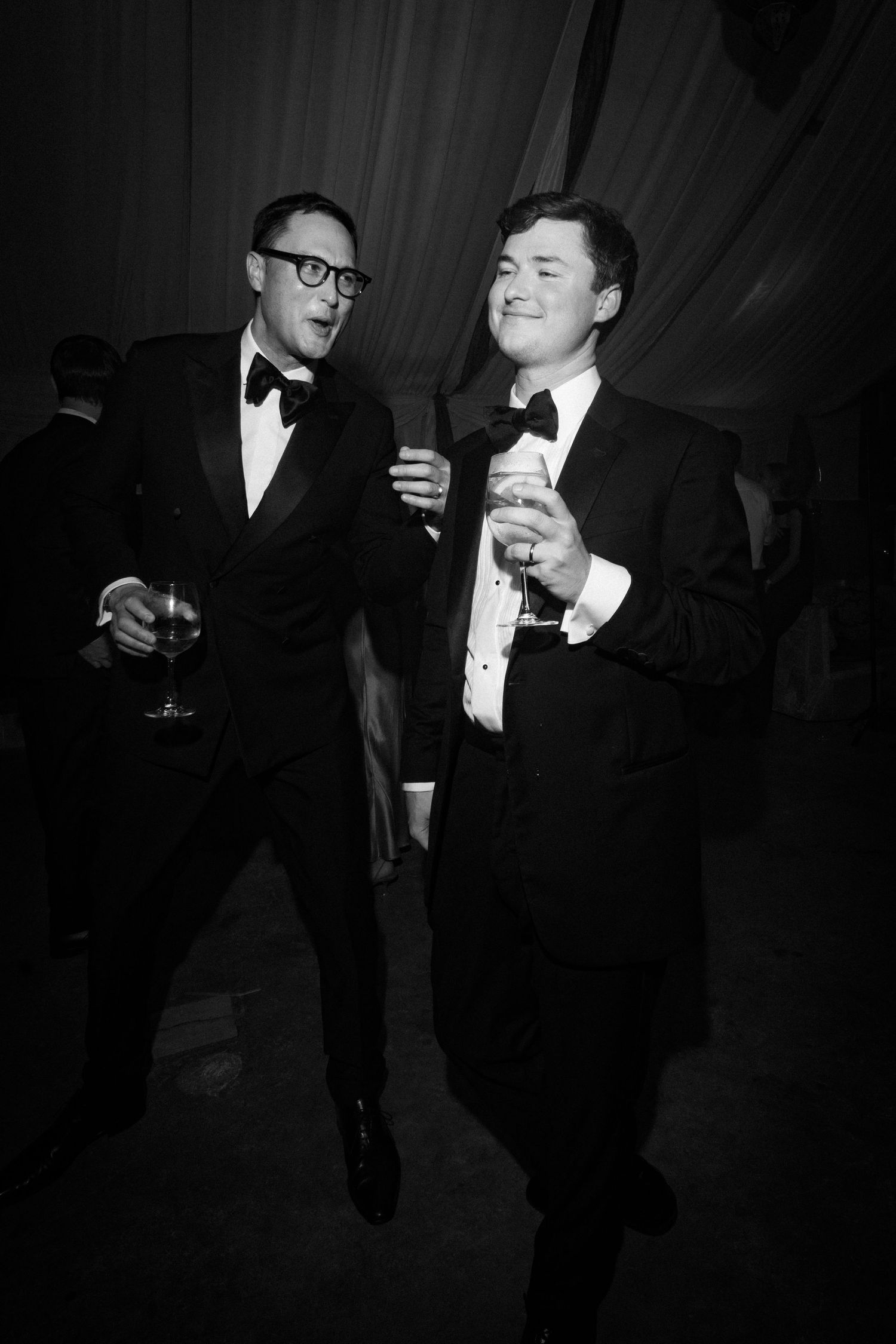 Elegant black and white photos of formal event guests socializing with drinks.