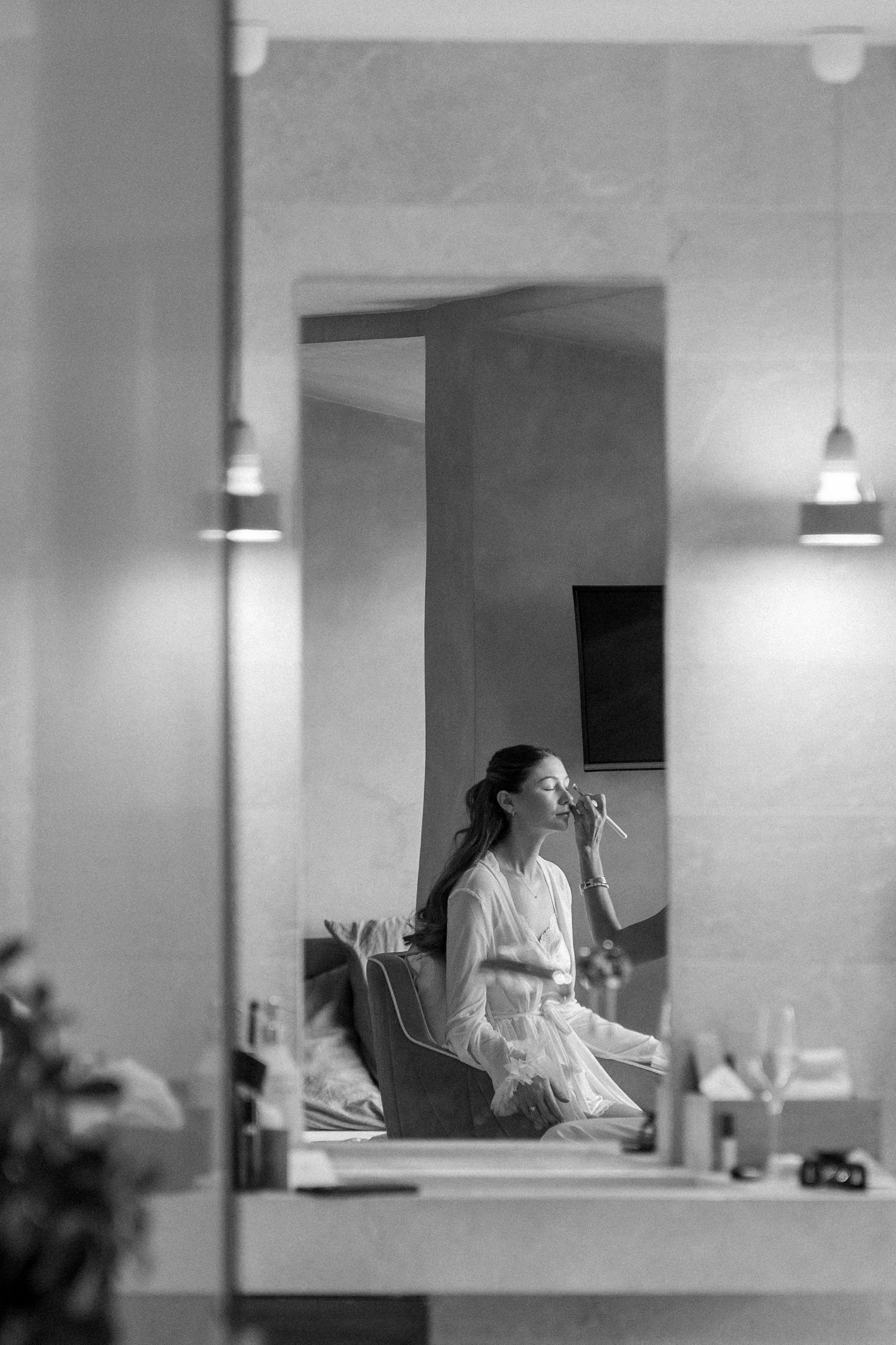 Black and white interior shots showing preparation moments in a minimalist room.