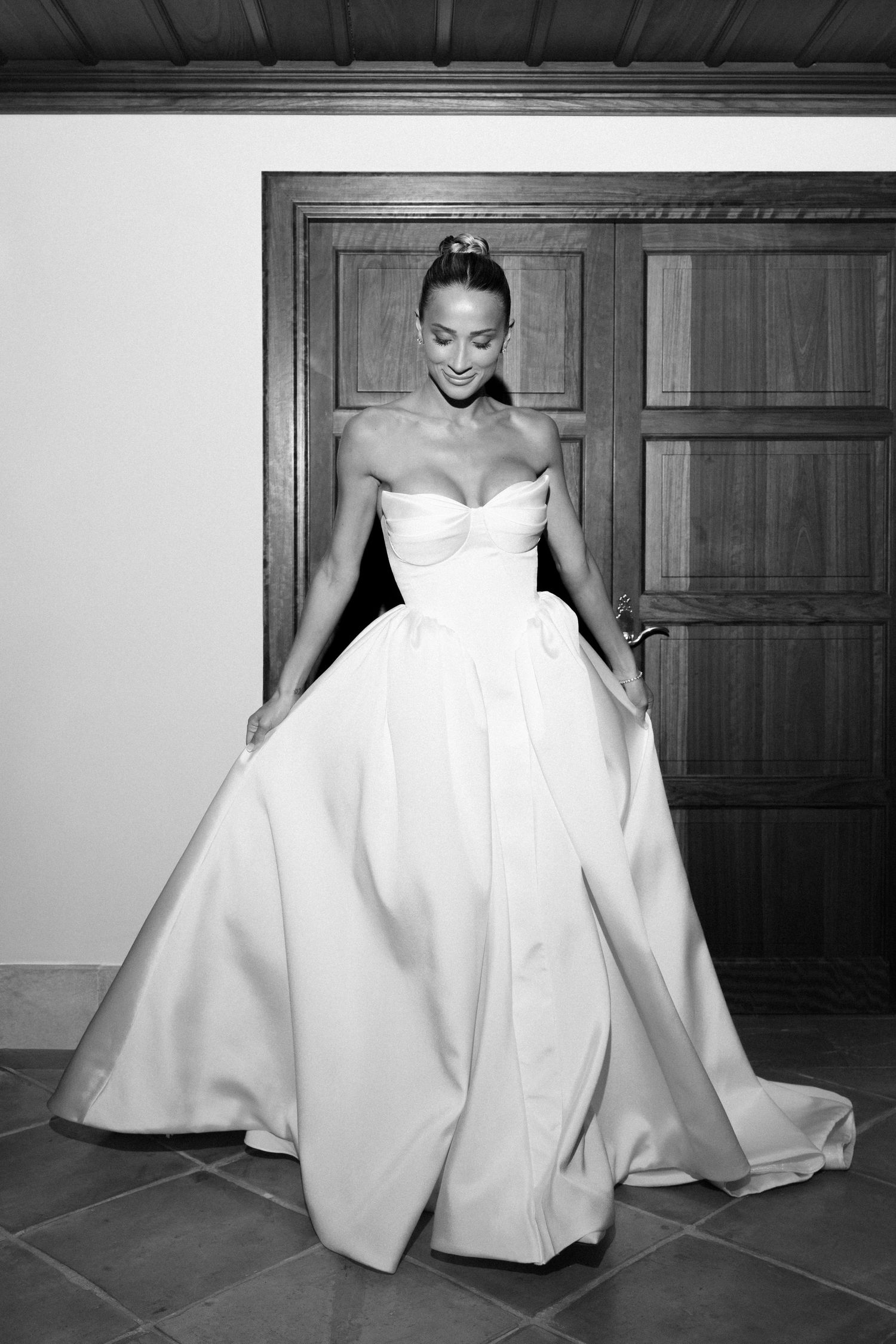 Series of black and white photos showing a flowing white wedding dress with dramatic folds and draping on a floor.
