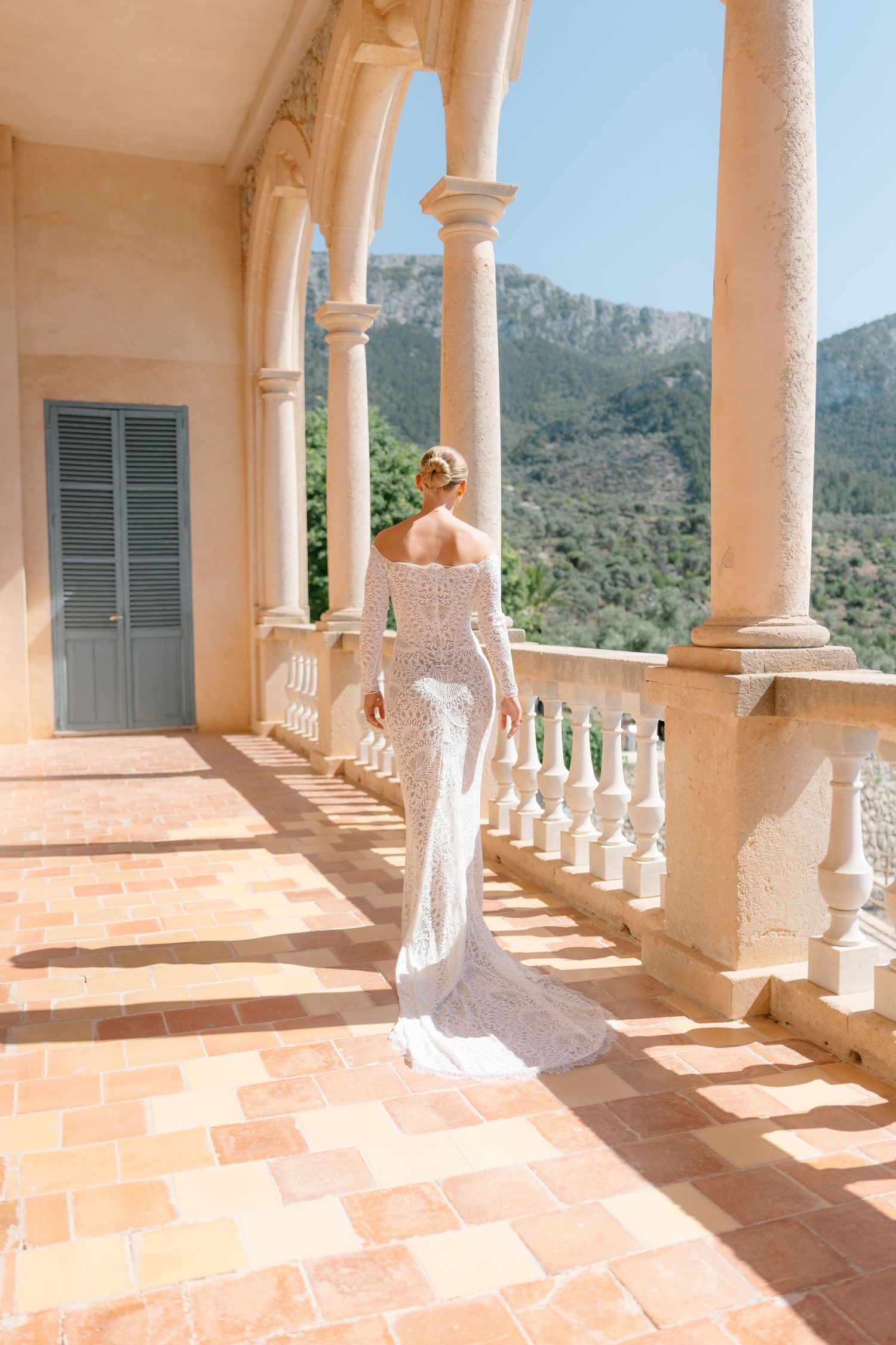 Sun-drenched Mediterranean terrace with classical columns and terra cotta tiles.