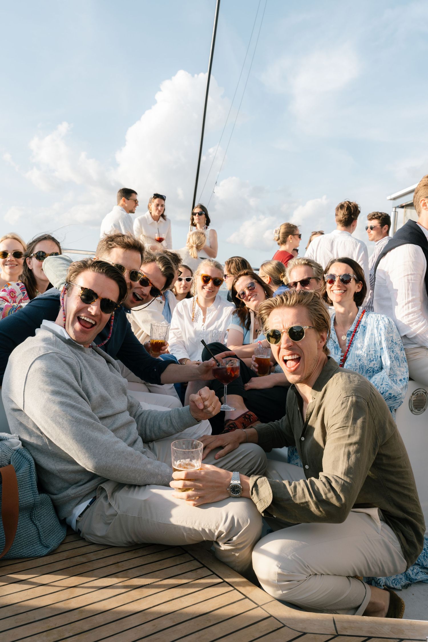 Friends lounging on a boat deck enjoying a sunny afternoon together.