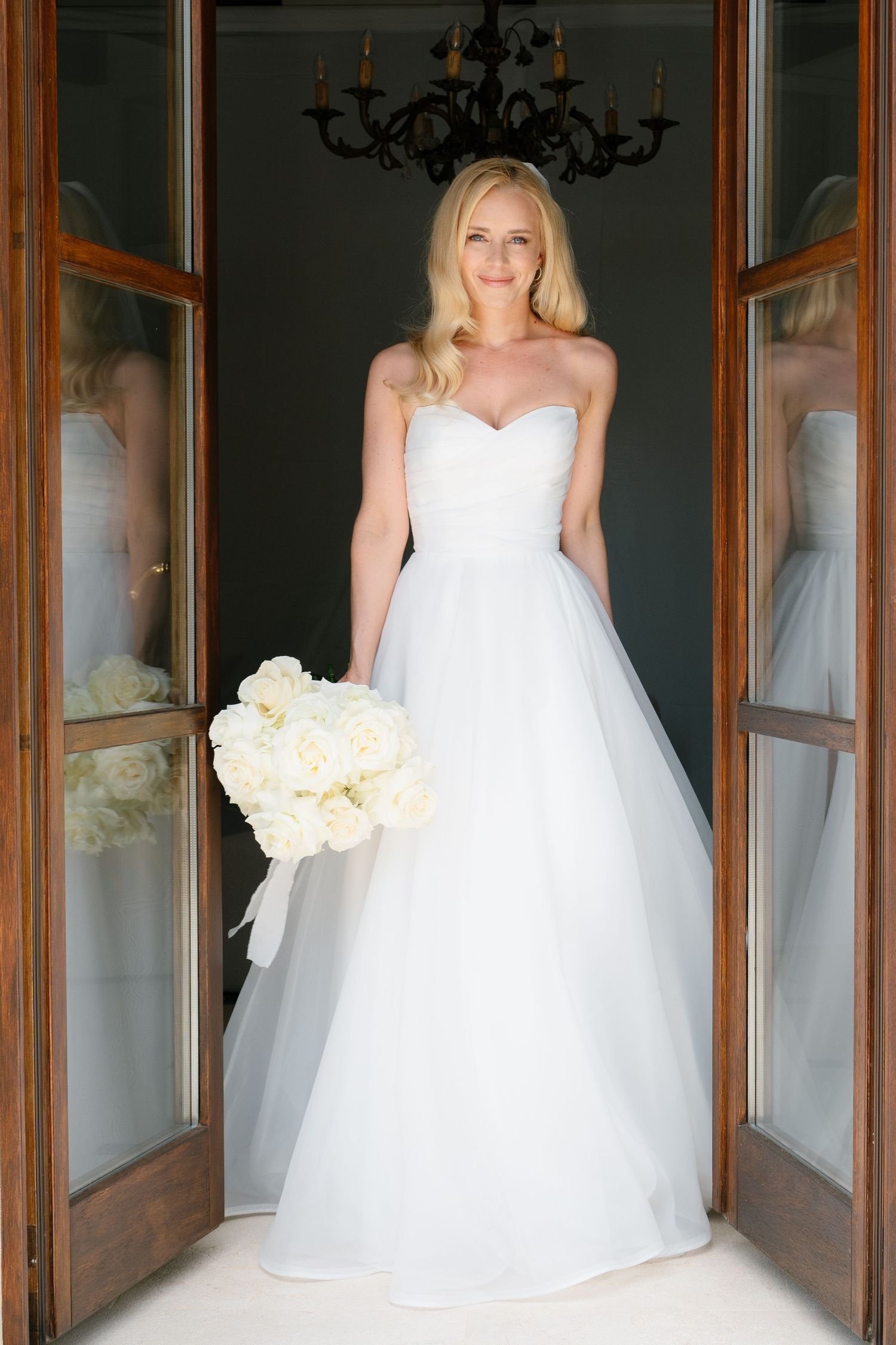 Elegant bridal portraits in white gown with reflections in wooden framed mirrors.
