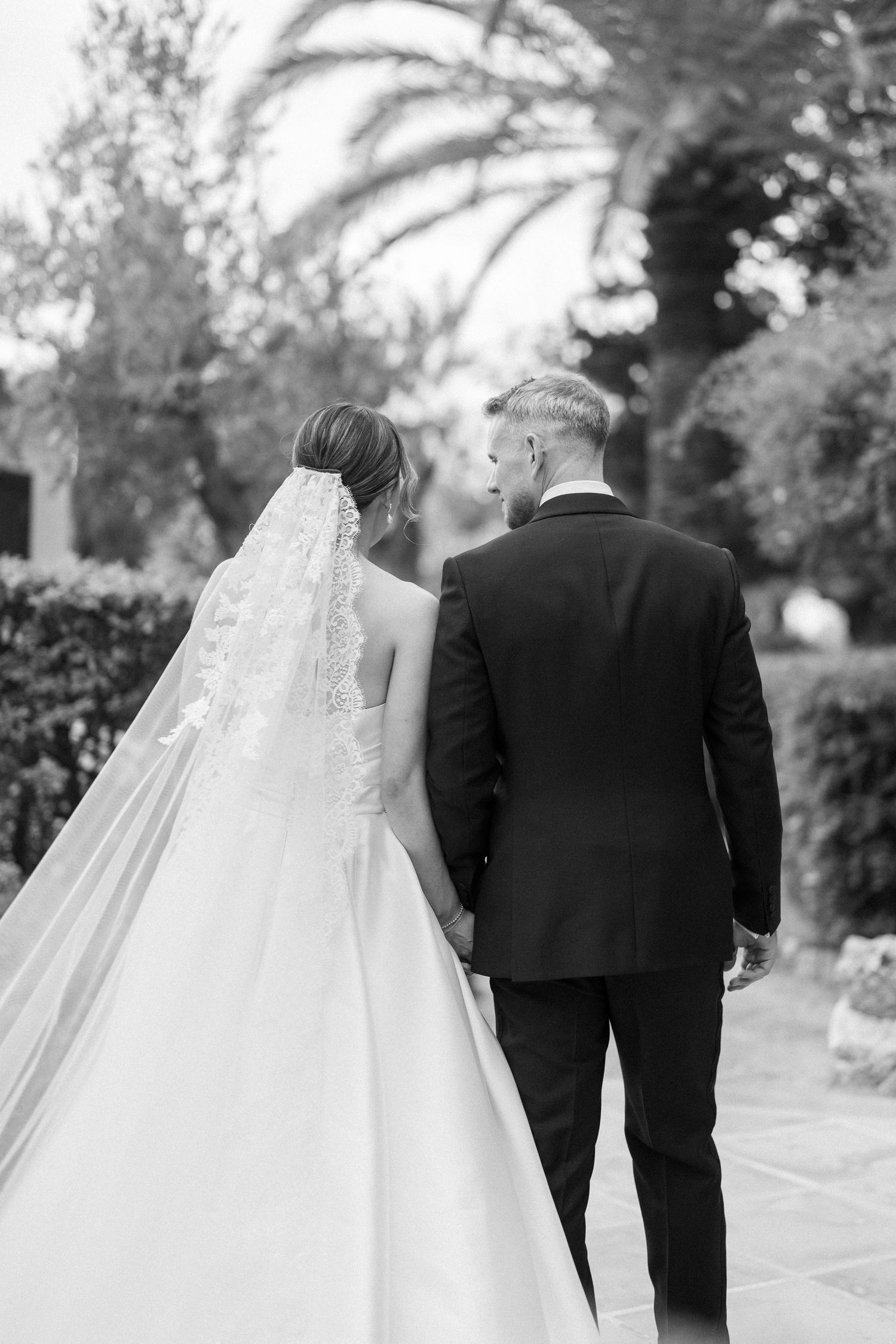 Black and white photo sequence of a couple walking together in formal wedding attire.
