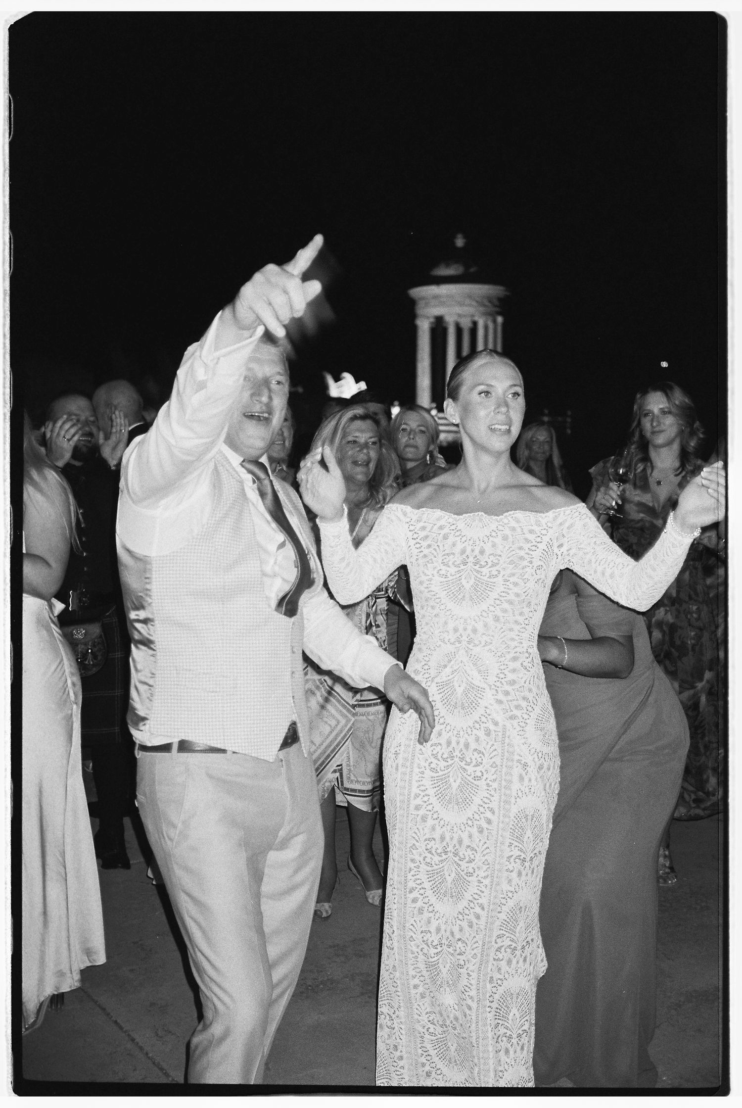 Wedding reception dance party captured in black and white photography.