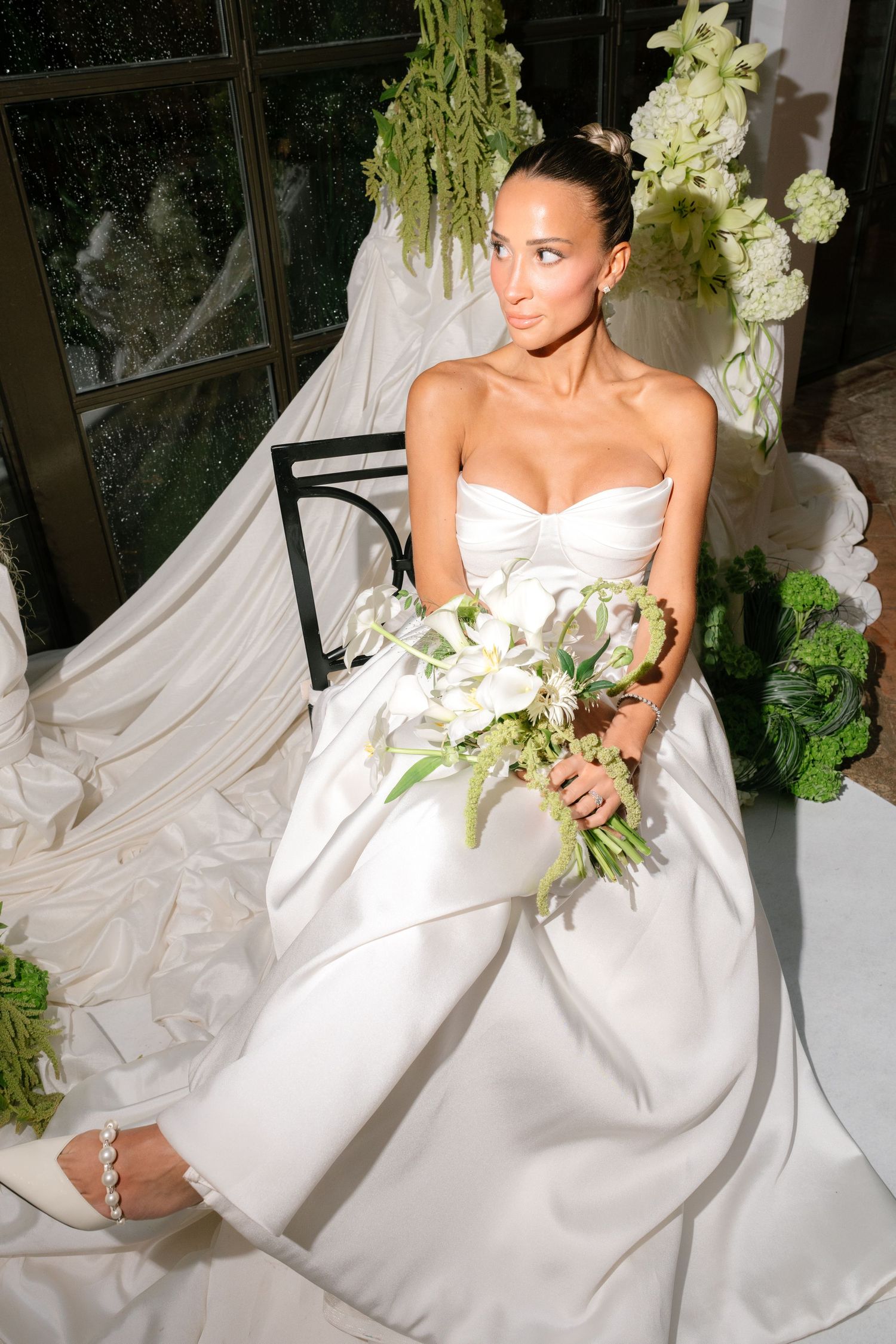 Series of wedding photos featuring a white strapless gown with cascading fabric and green floral bouquet accents.