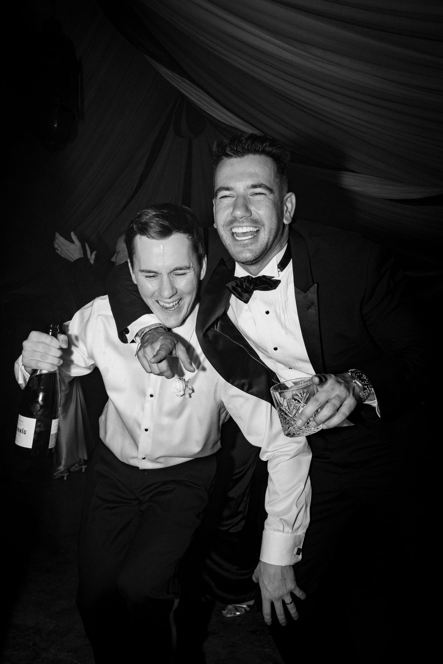 Black and white candid shots of guests laughing and celebrating at formal event.