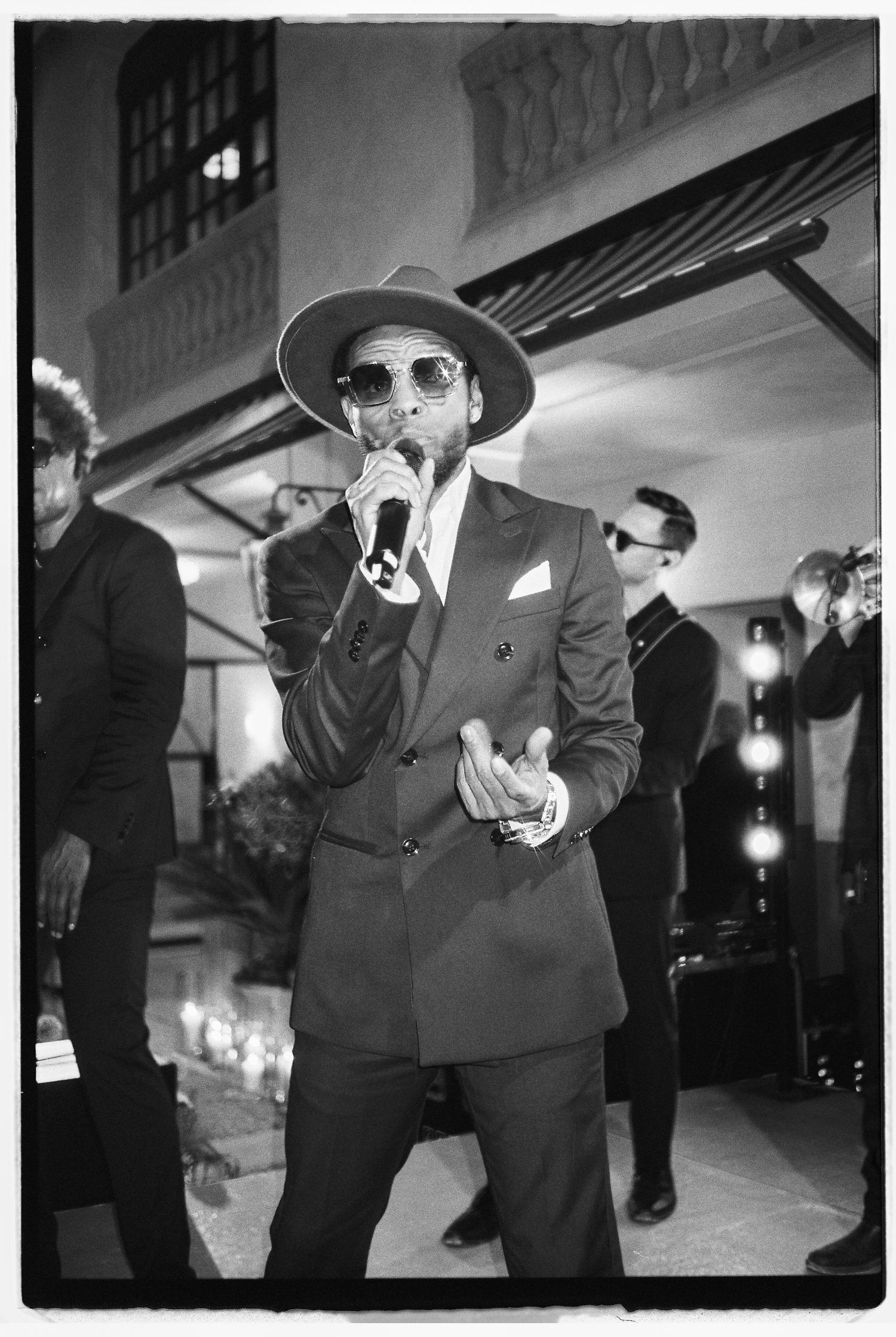 Black and white photos of performers in suits entertaining at an event.