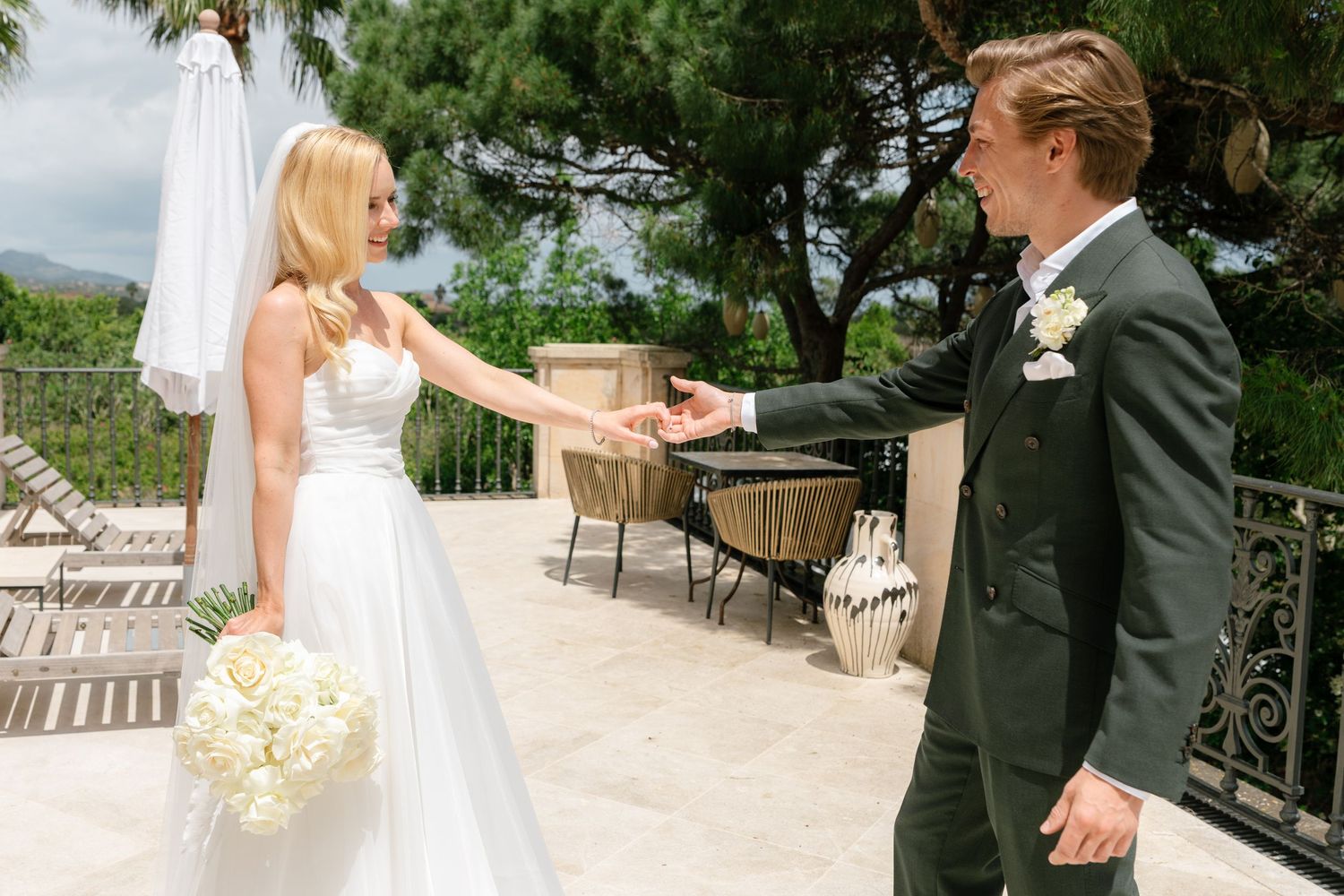 Sequence of wedding photos on a scenic terrace with palm trees and mountain views.