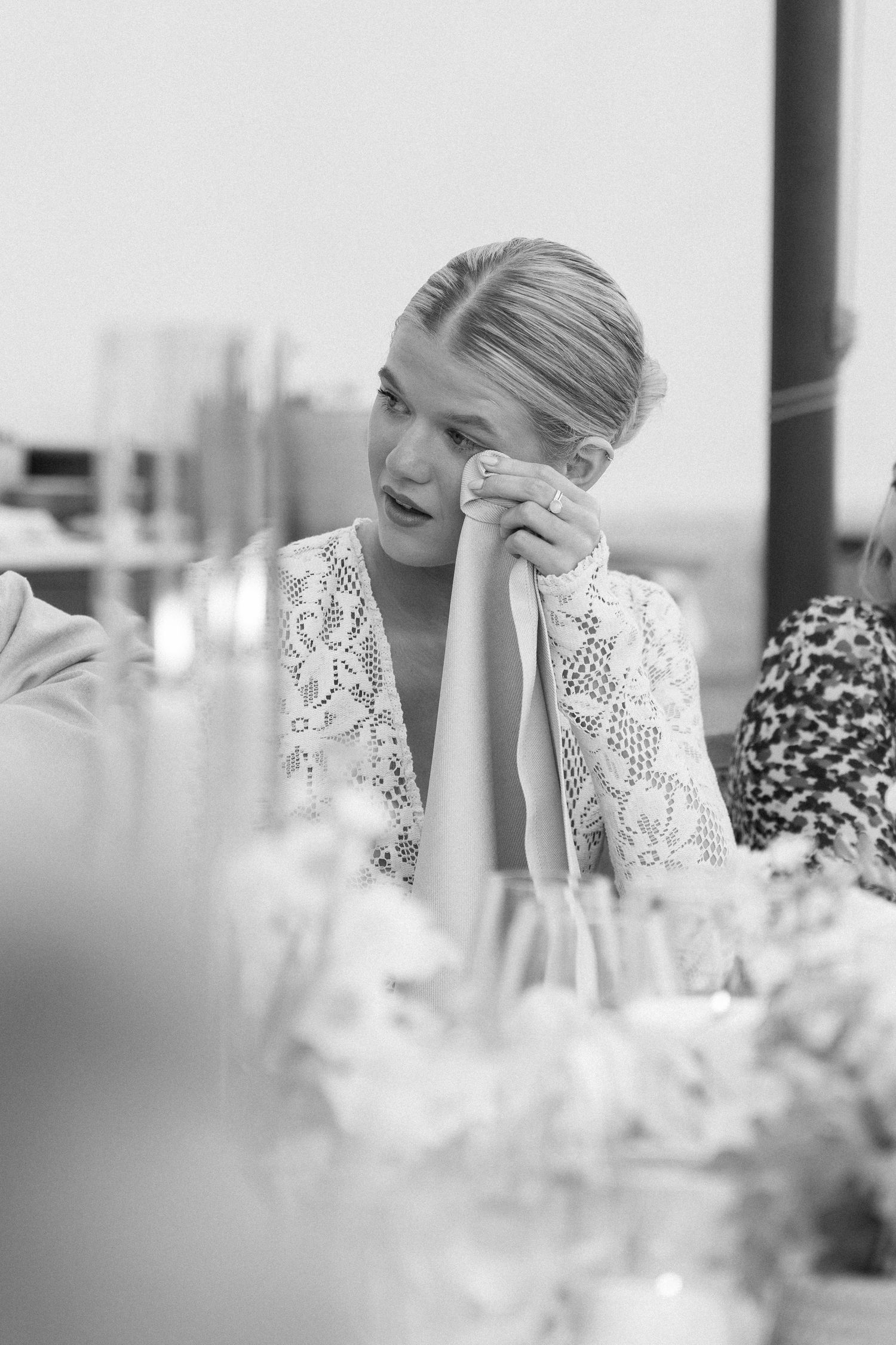 Elegant wedding table setting with white flowers and emotional moments captured.