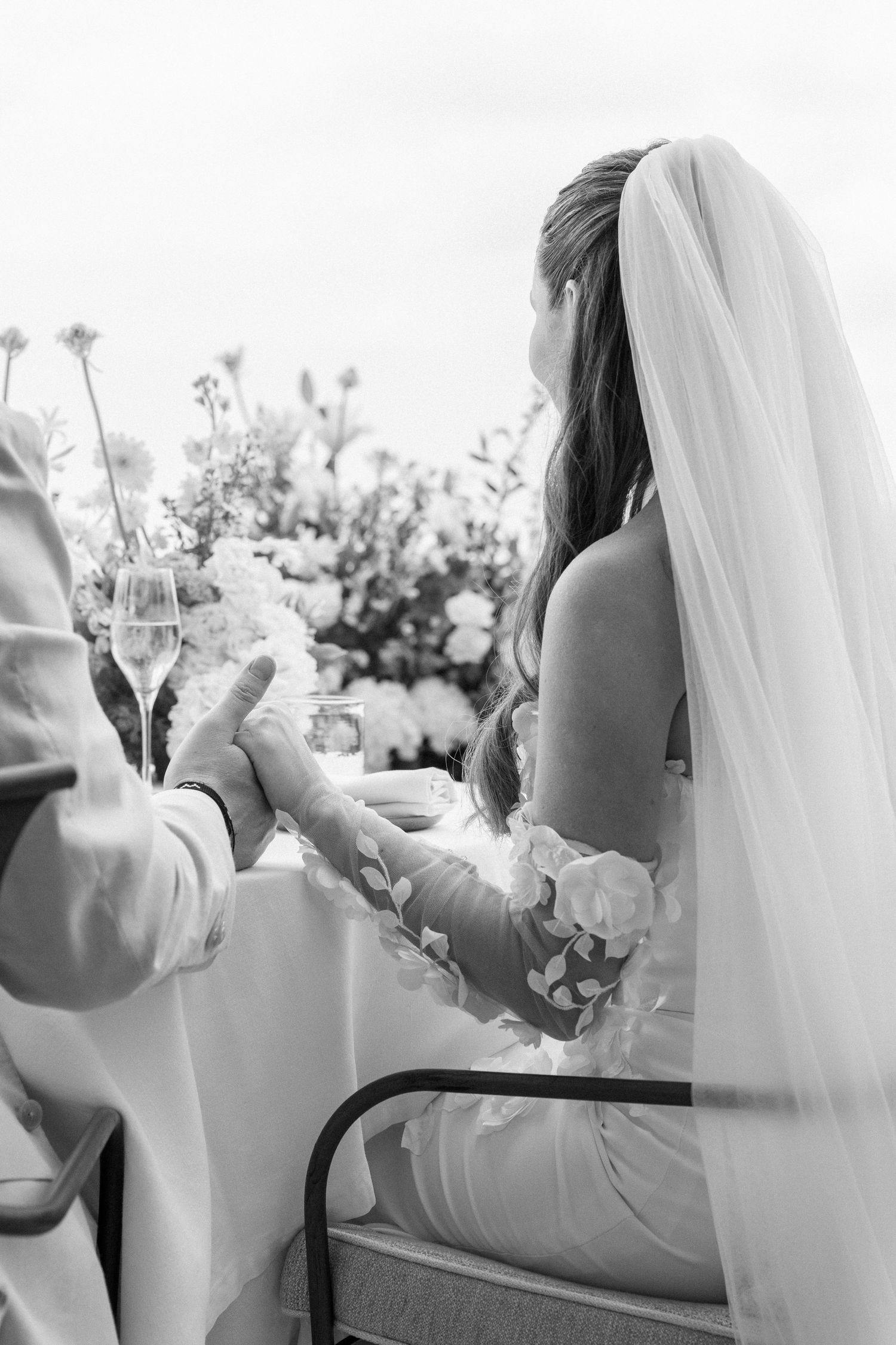 Candid black and white moments of a couple during their wedding celebration.