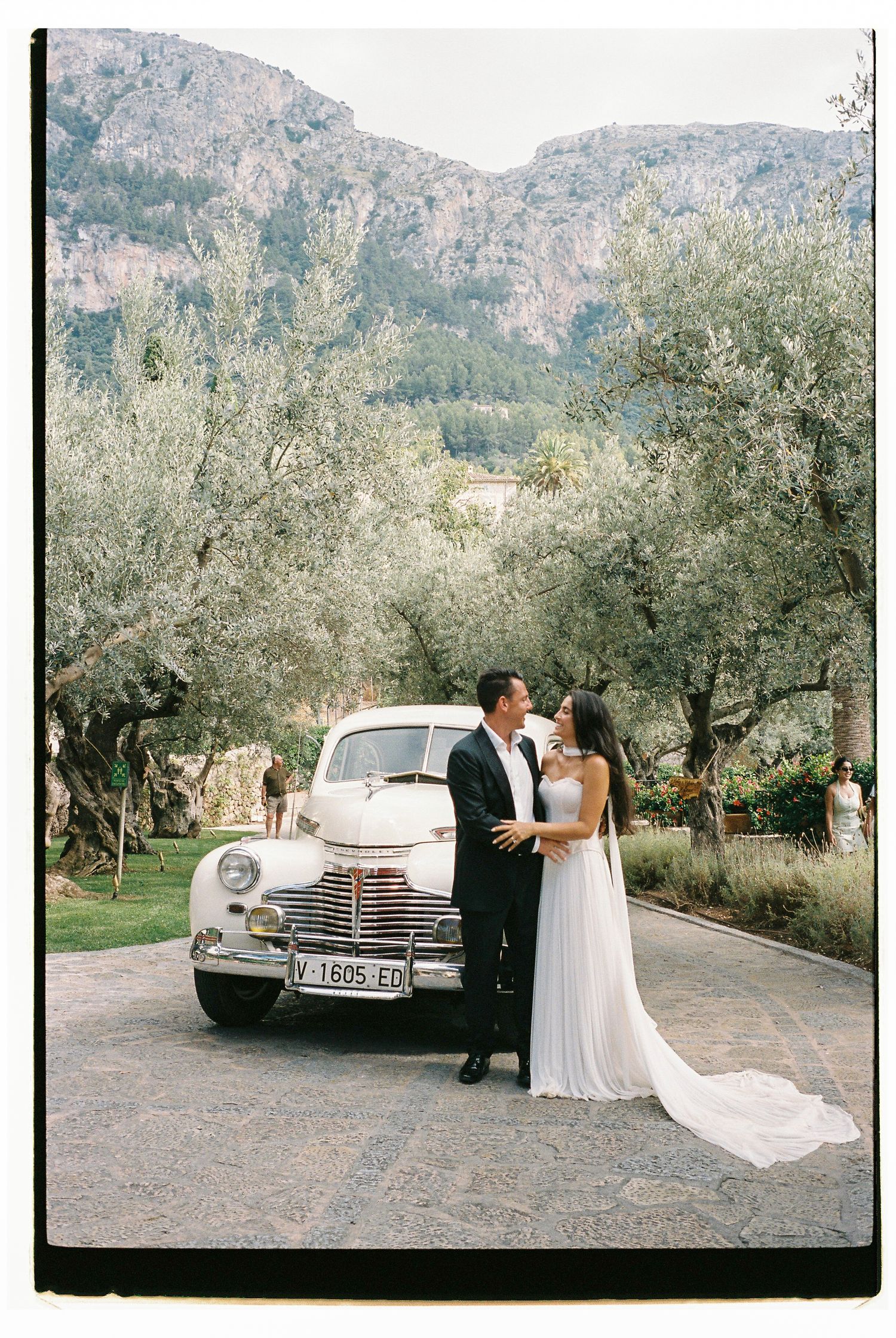 Classic vintage car parked in front of mountain landscape during wedding photoshoot at Belmond La Residencia.