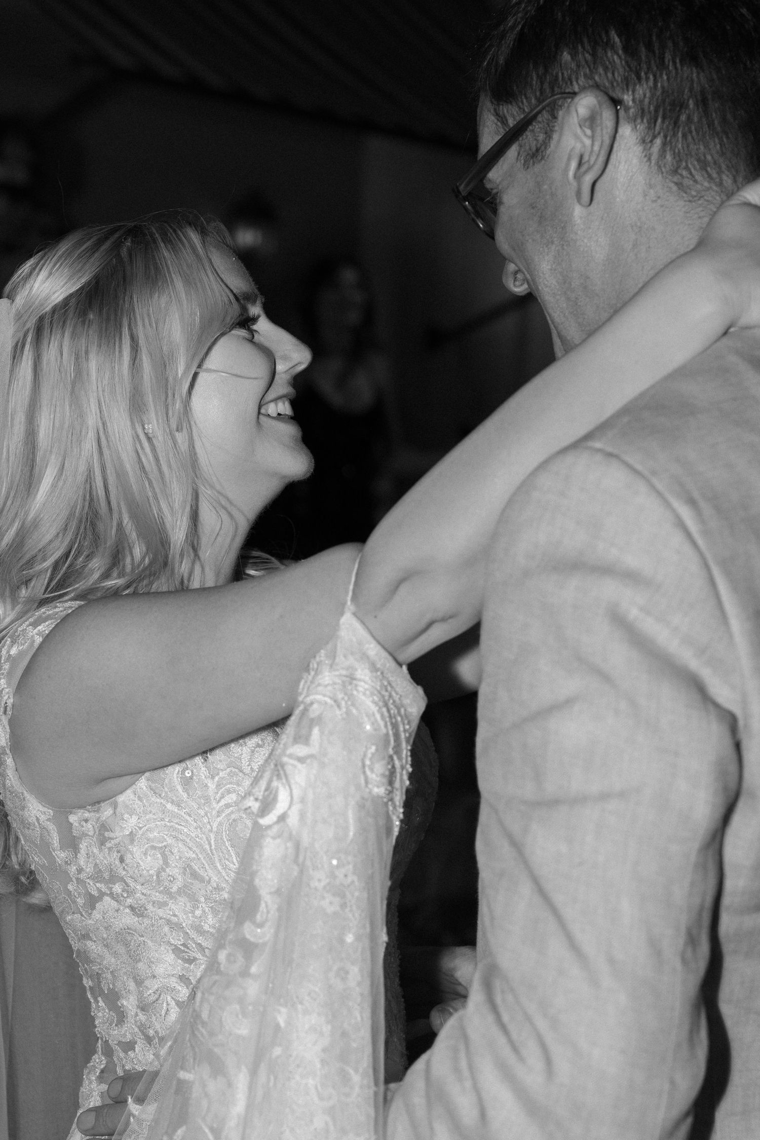 Romantic slow dance between couple in formal wedding attire.