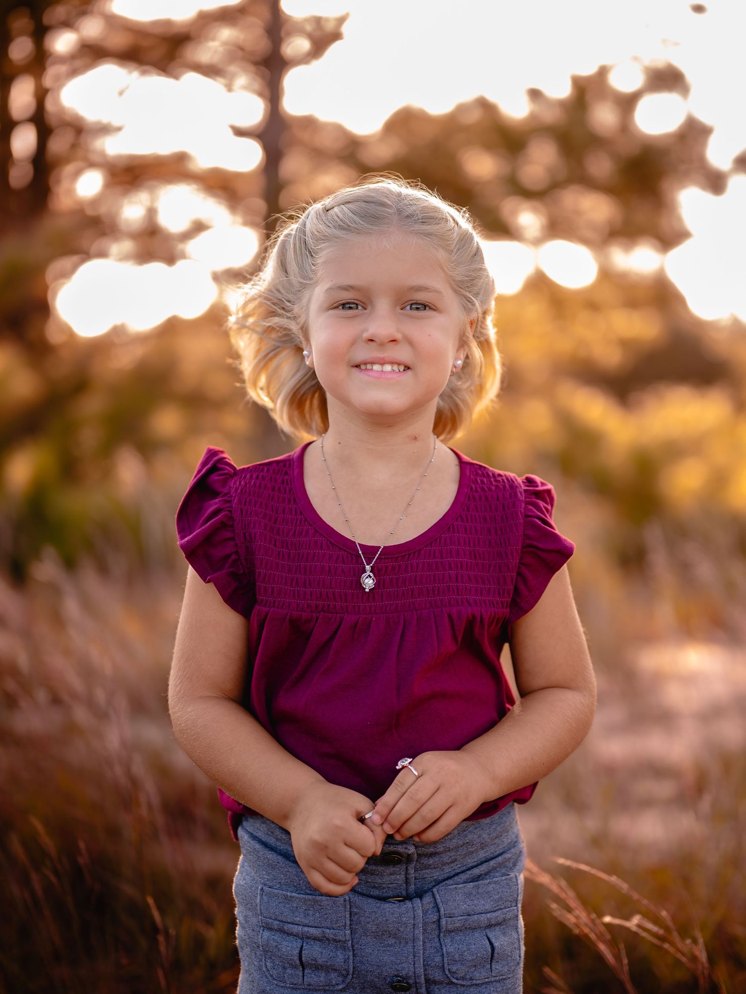 Little girl laughing in purple shirt at sunset, Chesapeake VA child photographer.