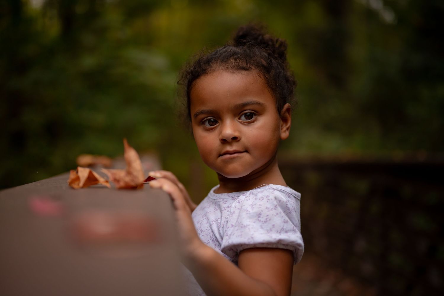 Toddler girl smiling shyly in soft sunset light, Chesapeake VA family photographer.