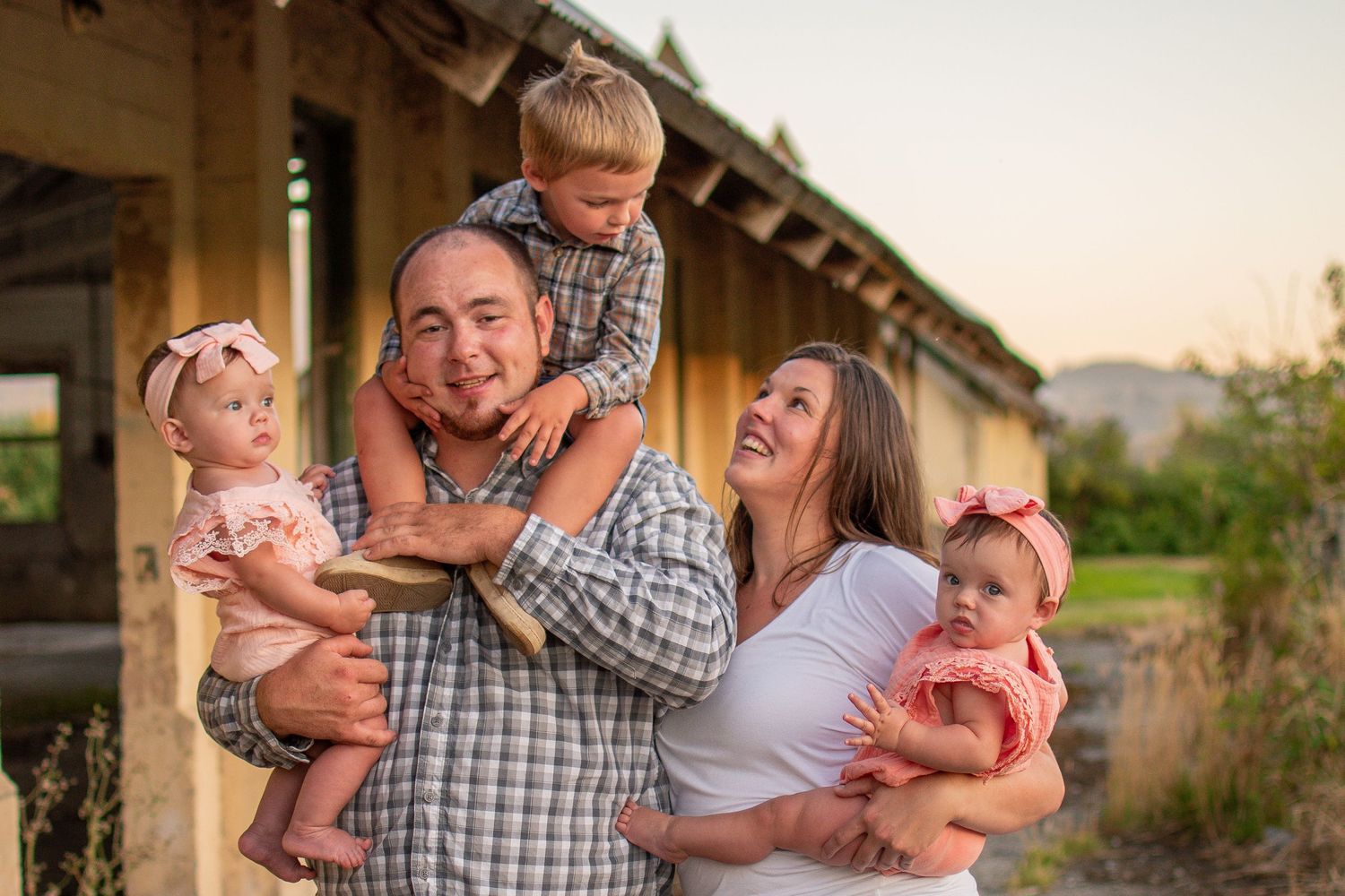 Family laughing together outdoors in golden light, Chesapeake Virginia lifestyle photography.