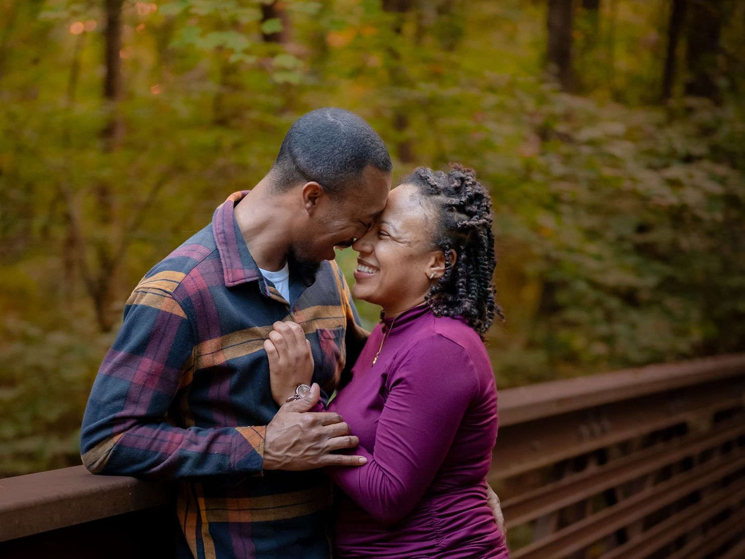 Couple sharing tender kiss on rustic bridge, Chesapeake VA couples photographer.
