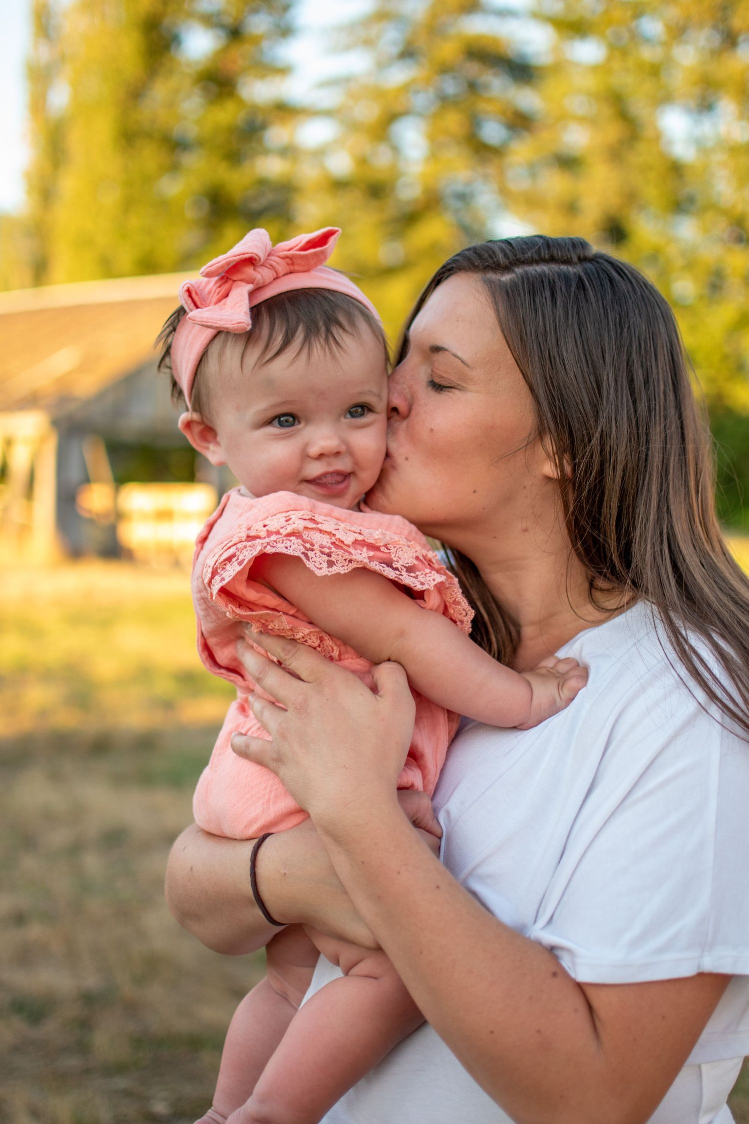 Mom cuddling baby girl in soft morning light, Chesapeake VA motherhood photographer.